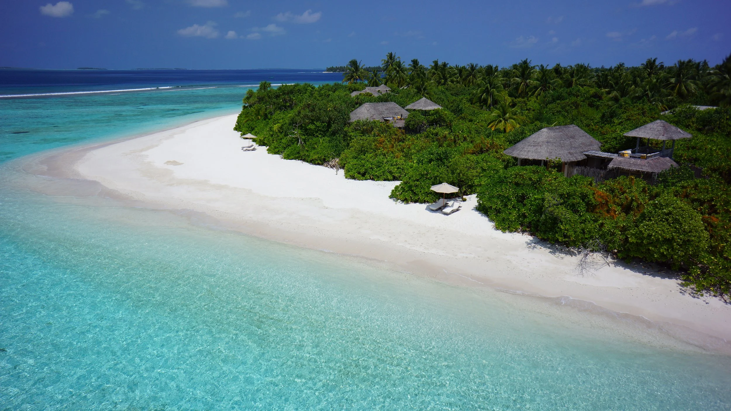 View of a beach, lagoon and villas