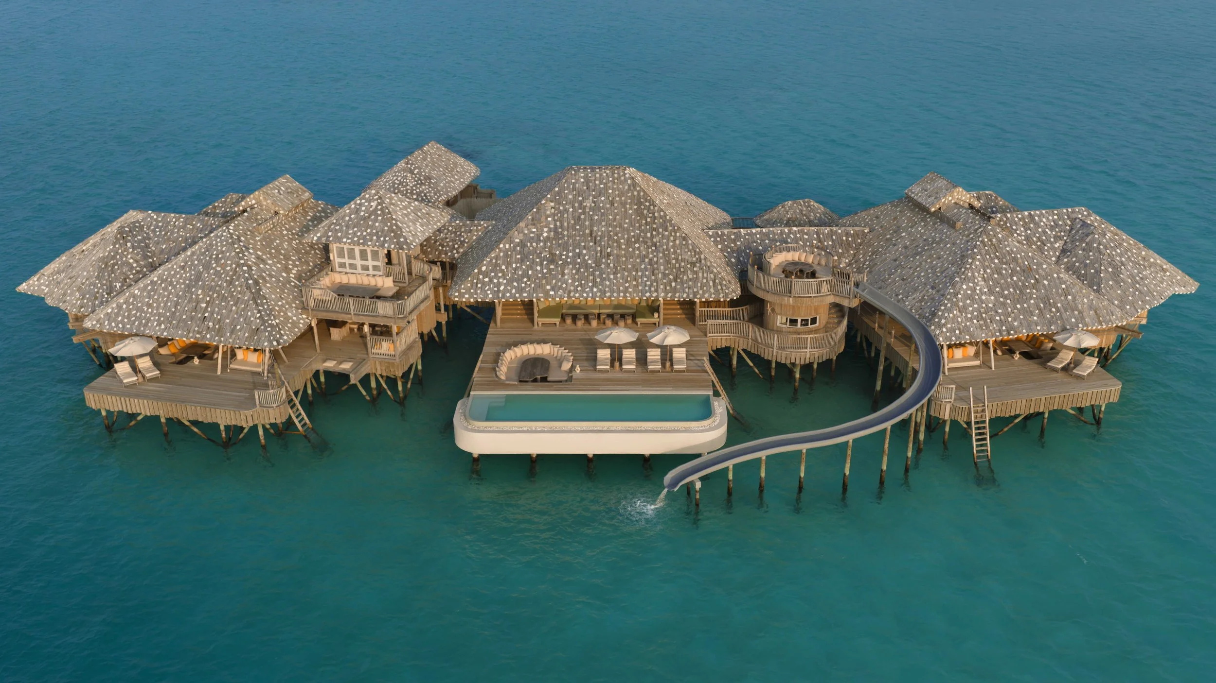 Aerial view of a very large overwater villa with pool and waterslide
