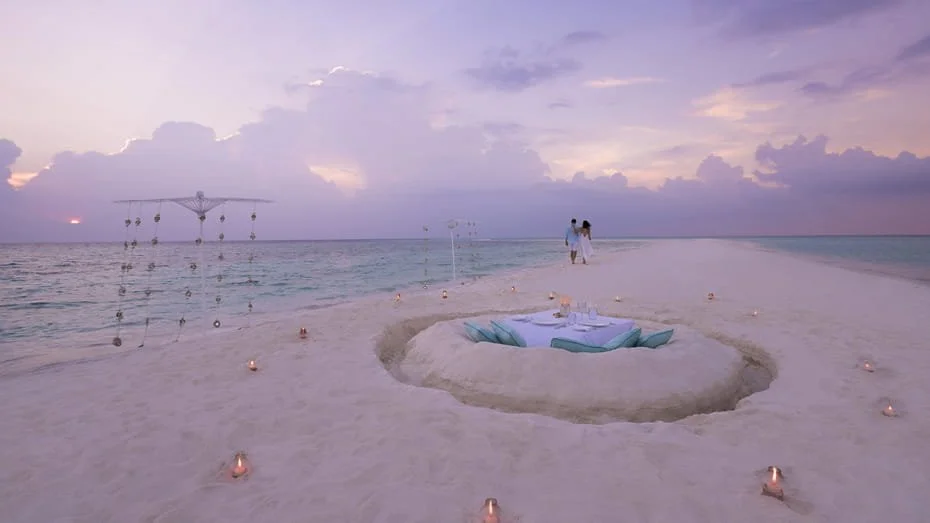 Couple on a sandbank with a table made from the sand