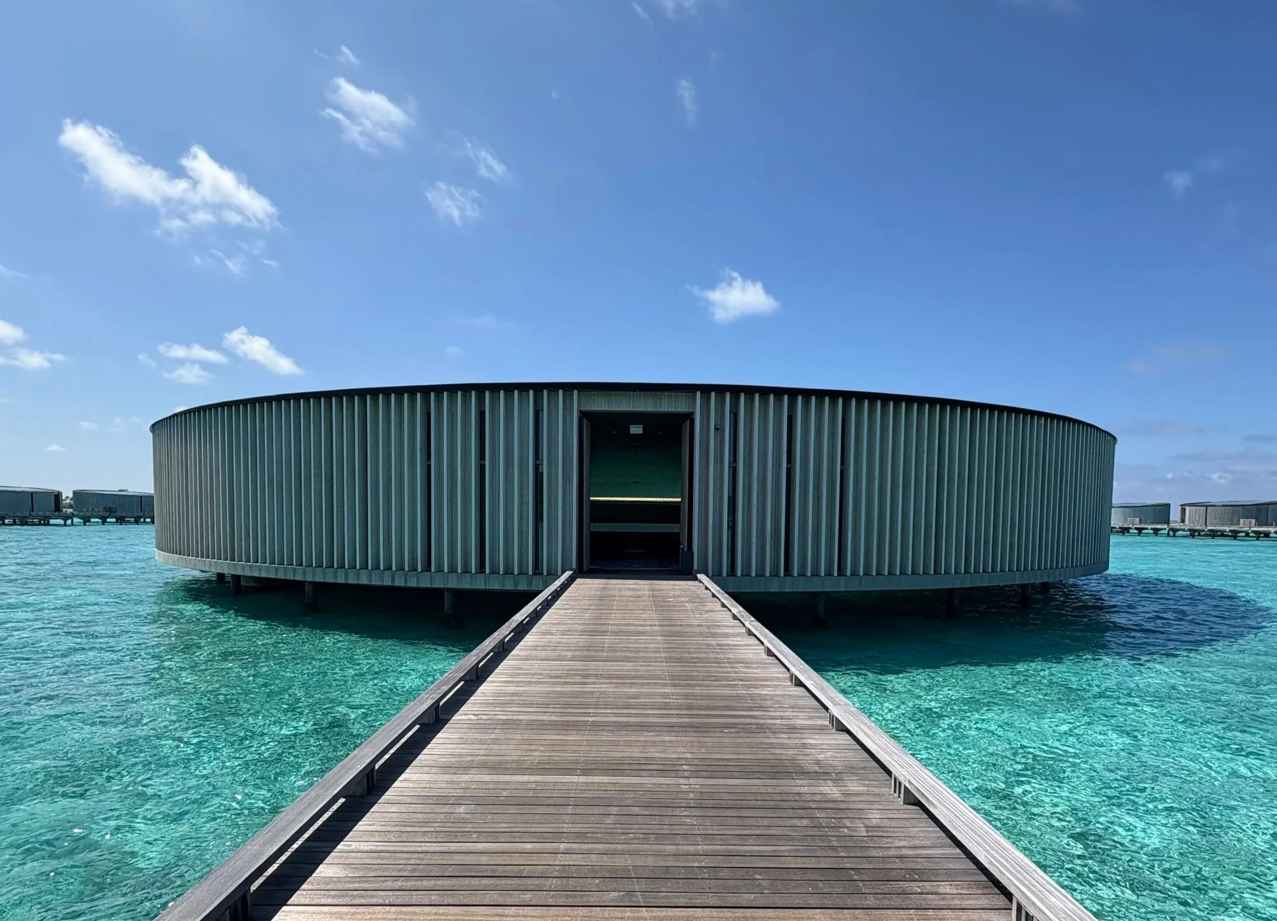 round overwater spa building connected by a bridge