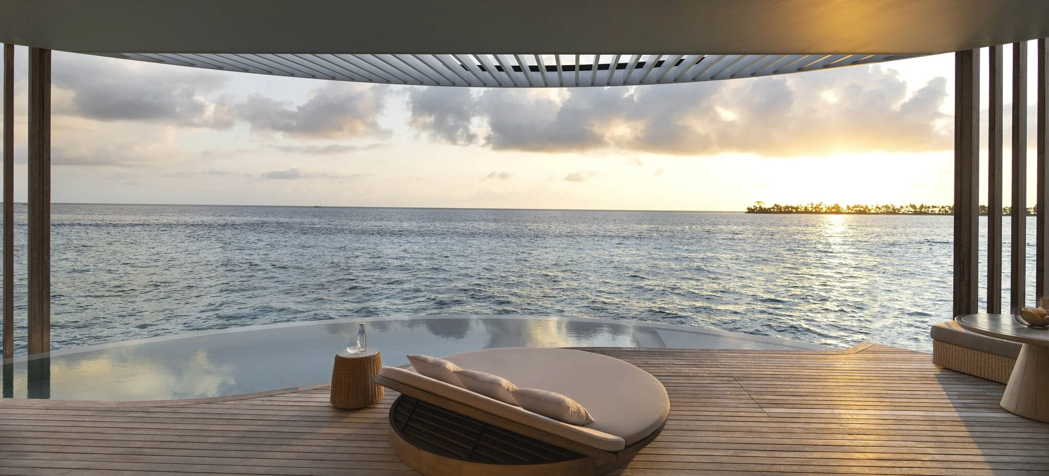 Overwater pool villa looking out at the sunset