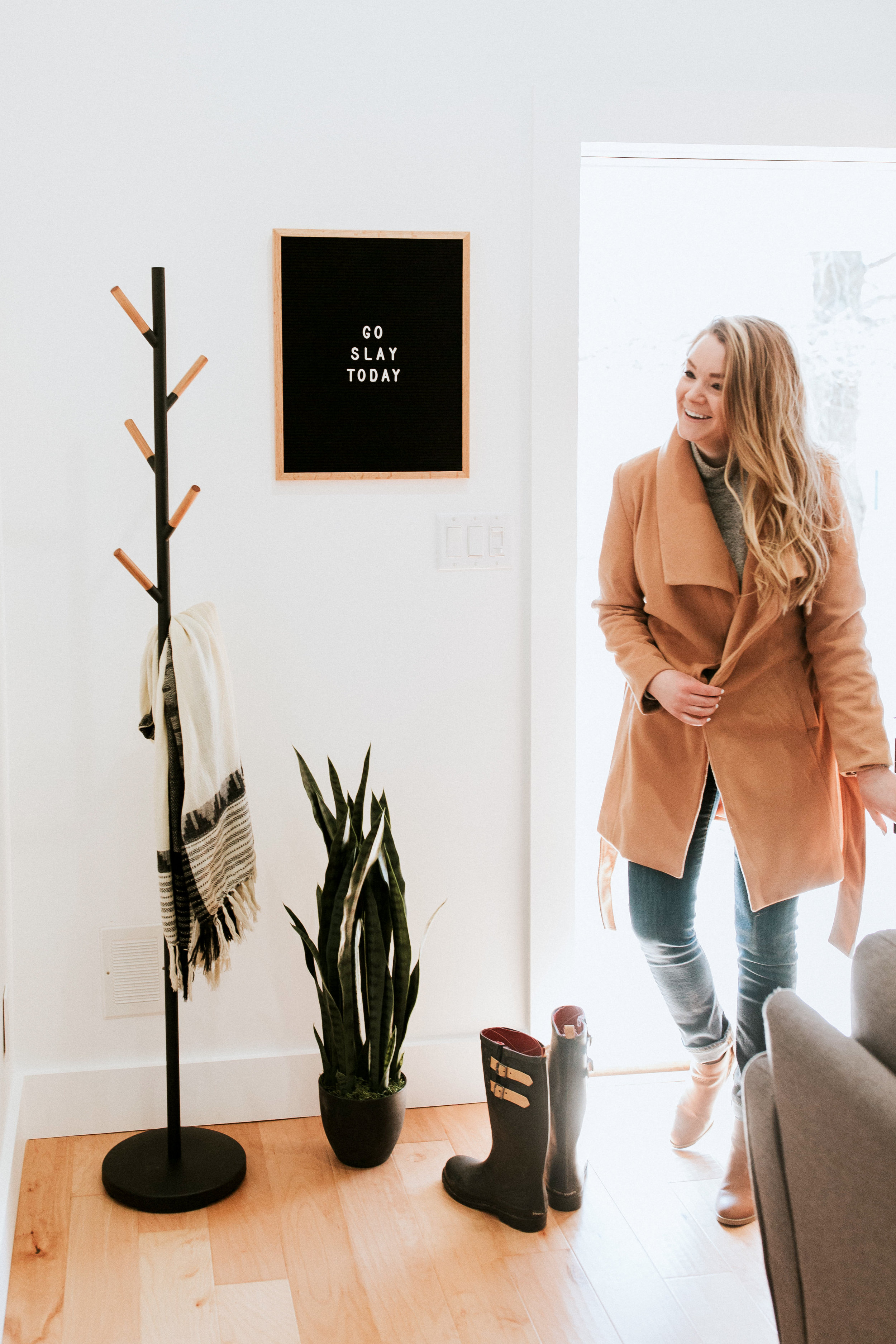 how we styled our entryway - modern minimal style inspiration featuring industrial coat rack, letterboard, and snake plant