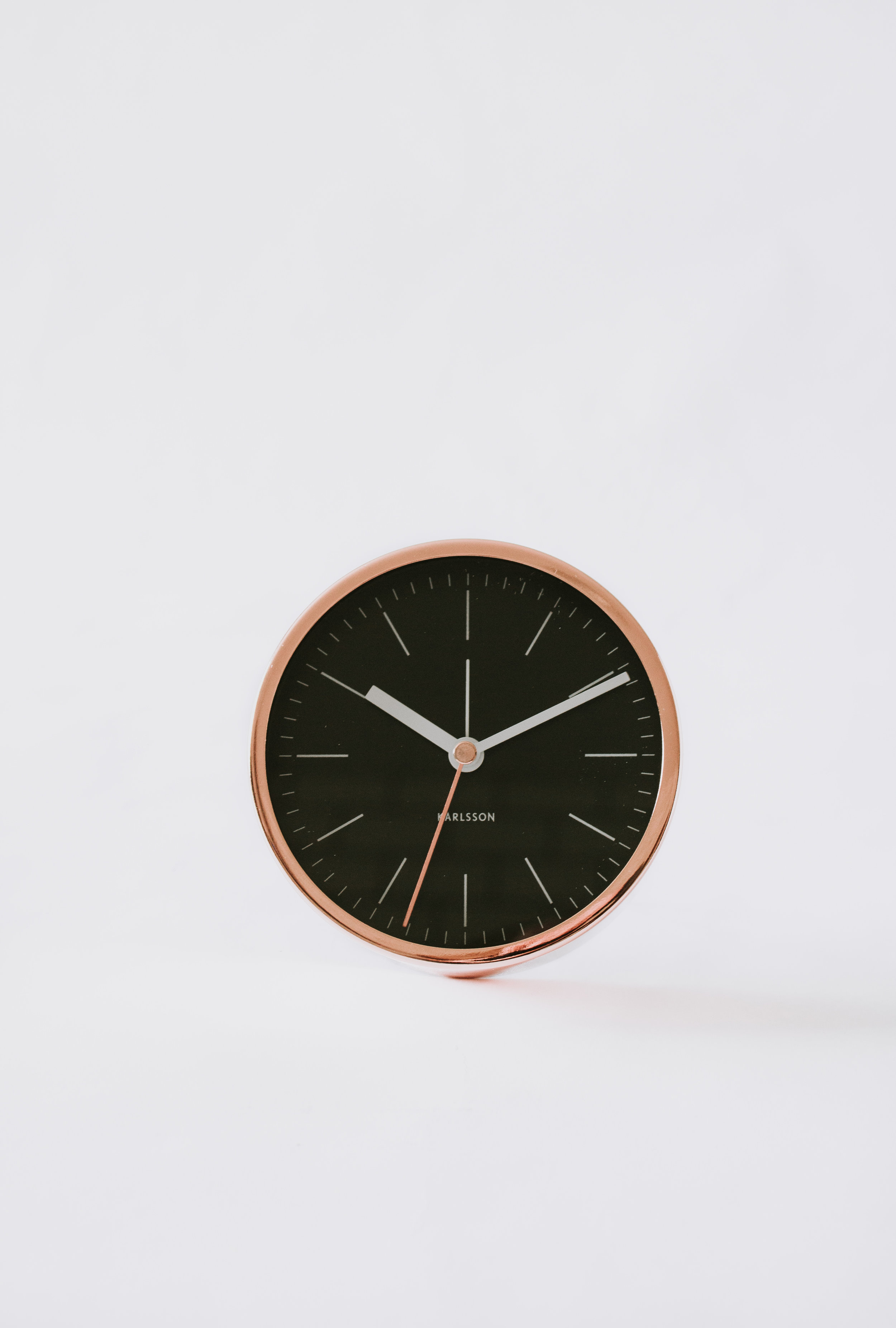 Joline Alarm Clock by Nadine Stay - Copper / Rose Gold finish with a black clock face and white hands.