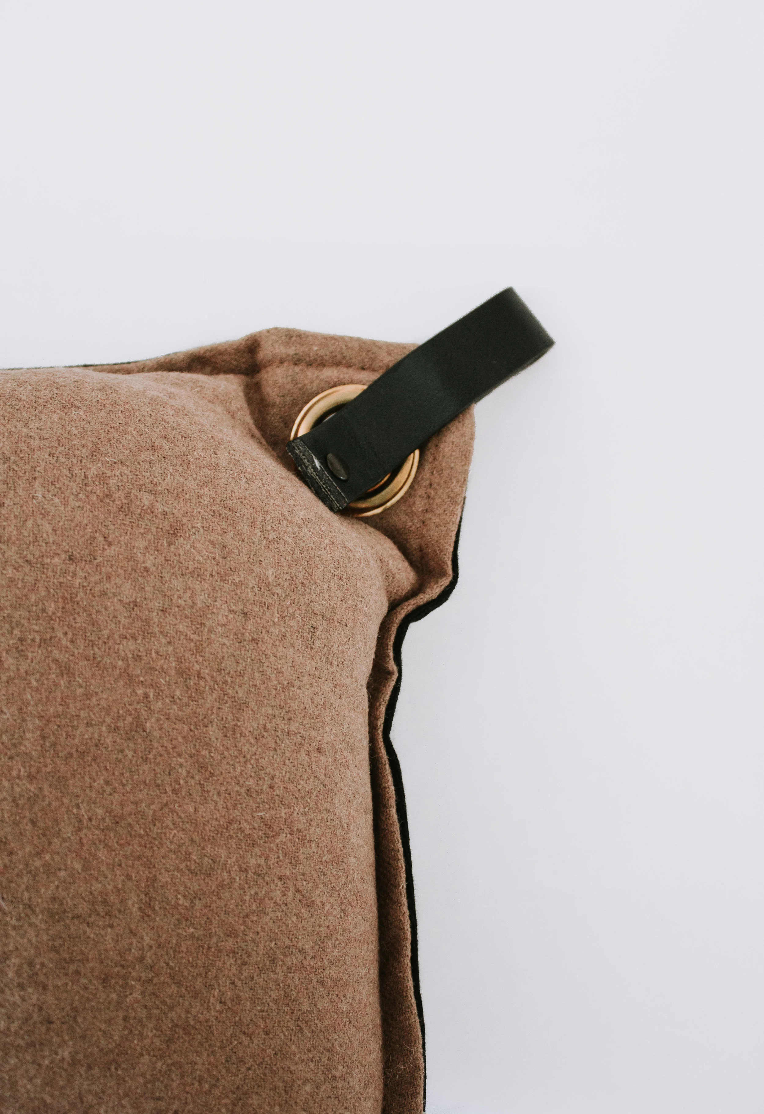 Malik Pillow in Brown by Nadine Stay - Lumbar pillow with a leather strap and brass ring. Modern throw pillow