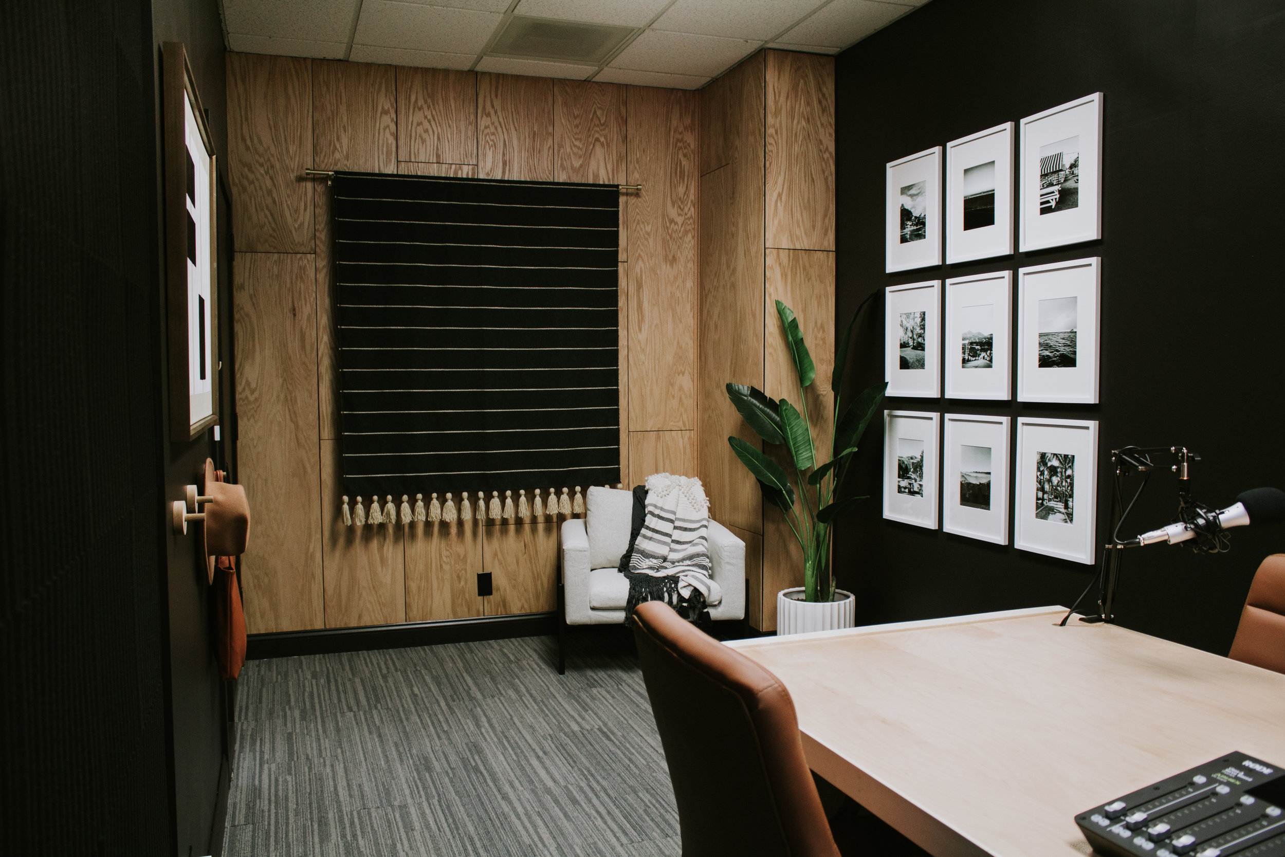 Speak Podcast Studio Reveal! Full transformation and makeover by Nadine Stay. Speak Podcast Studio is located in Lincoln, Nebraska. A podcast recording studio. Modern & moody office makeover with black walls, oak wood accent wall, and modern artwork…