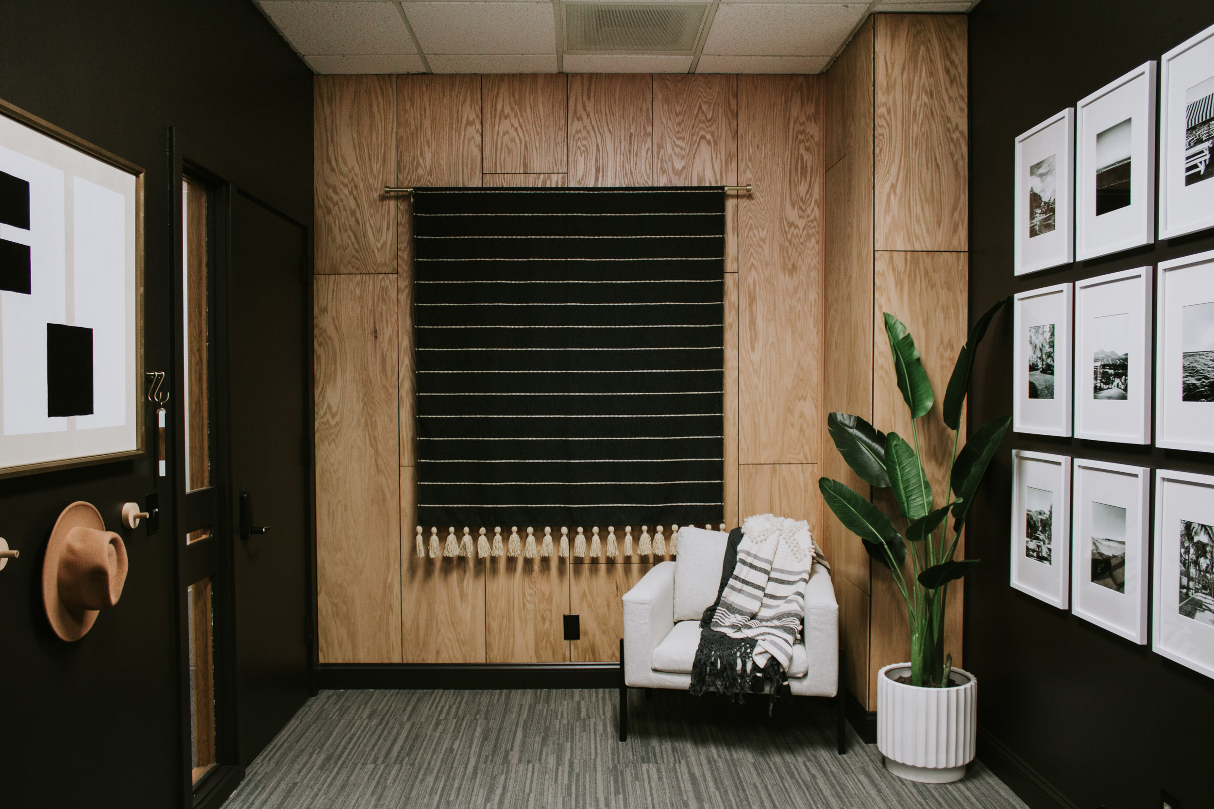 Speak Podcast Studio Reveal! Full transformation and makeover by Nadine Stay. Speak Podcast Studio is located in Lincoln, Nebraska. A podcast recording studio. Modern & moody office makeover with black walls, oak wood accent wall, and modern artwork…