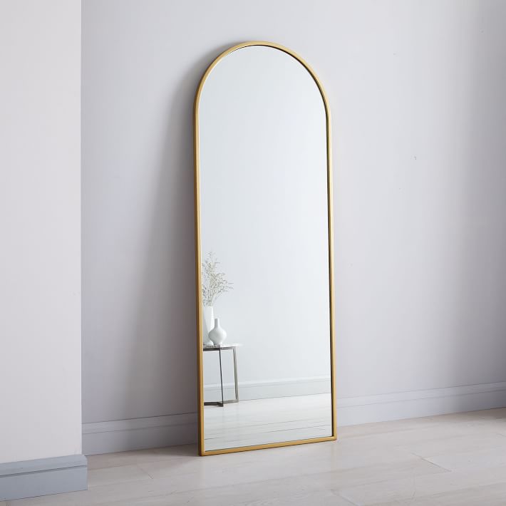 The High/Low List by Nadine Stay - Featuring Brass Accents. High end pieces and their (cheaper) twins. Brass home decor, furniture, and accessories. Brass arched mirror from West Elm.