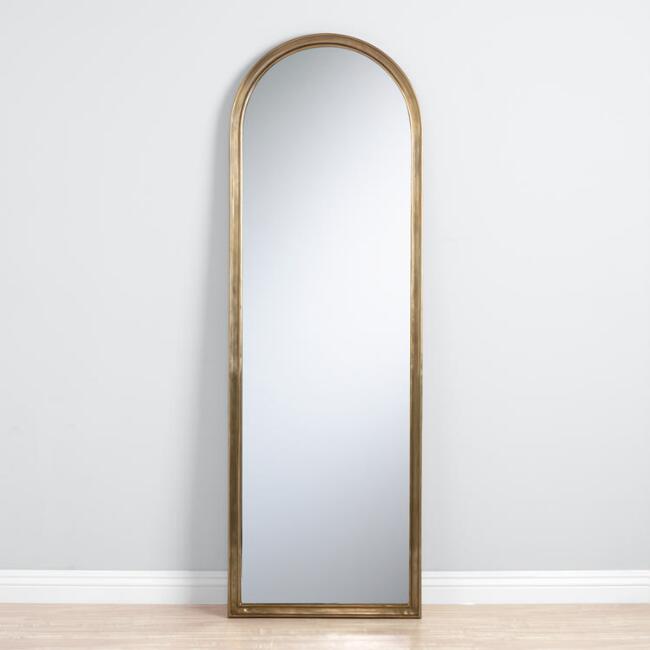 The High/Low List by Nadine Stay - Featuring Brass Accents. High end pieces and their (cheaper) twins. Brass home decor, furniture, and accessories. Brass arched mirror from World Market.