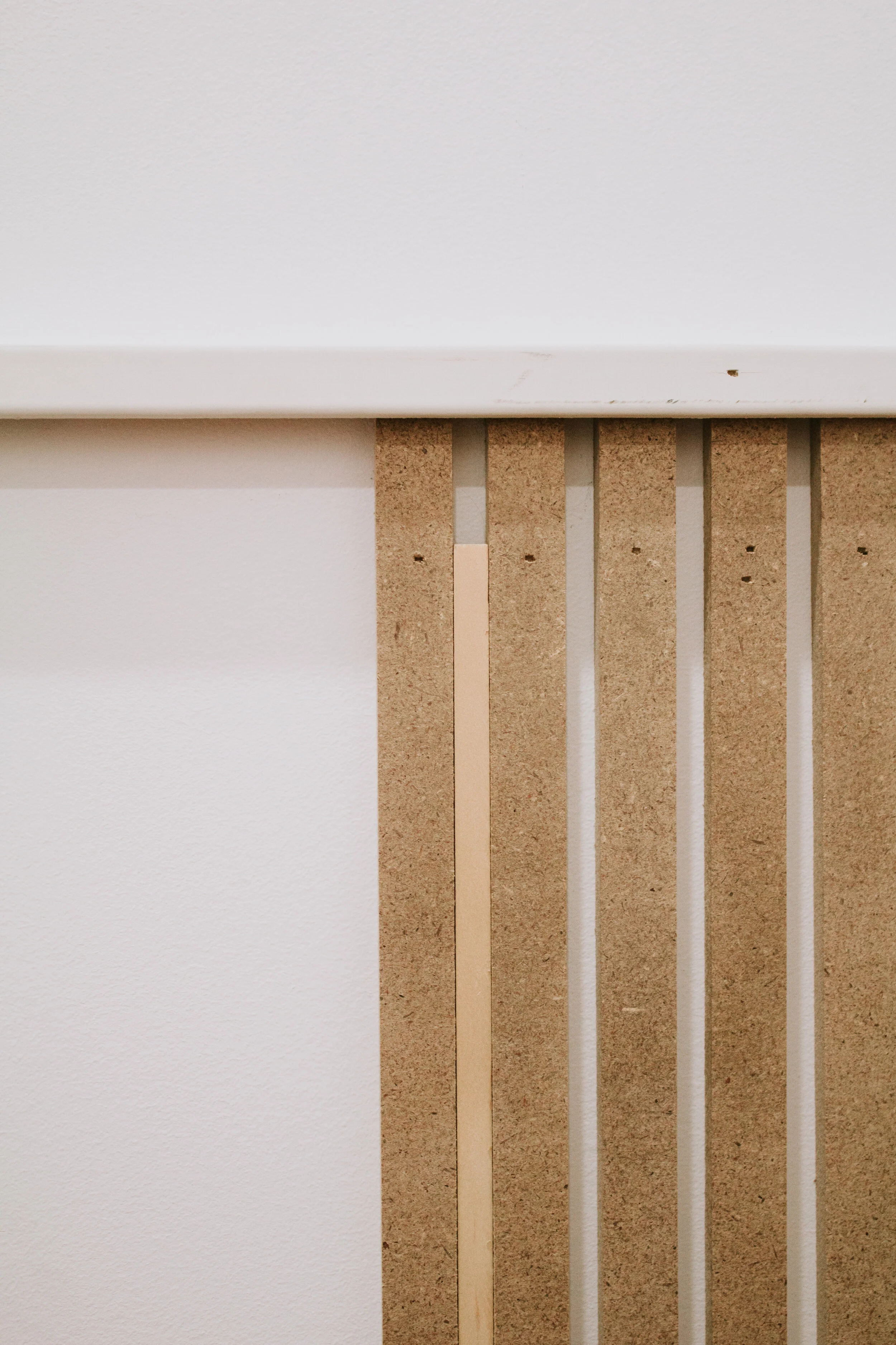 Installing modern wainscoting in our home office. Office makeover by Nadine Stay. Vertical slats painted in a rich hunter green. Full tutorial - how to install modern wainscoting in your home.