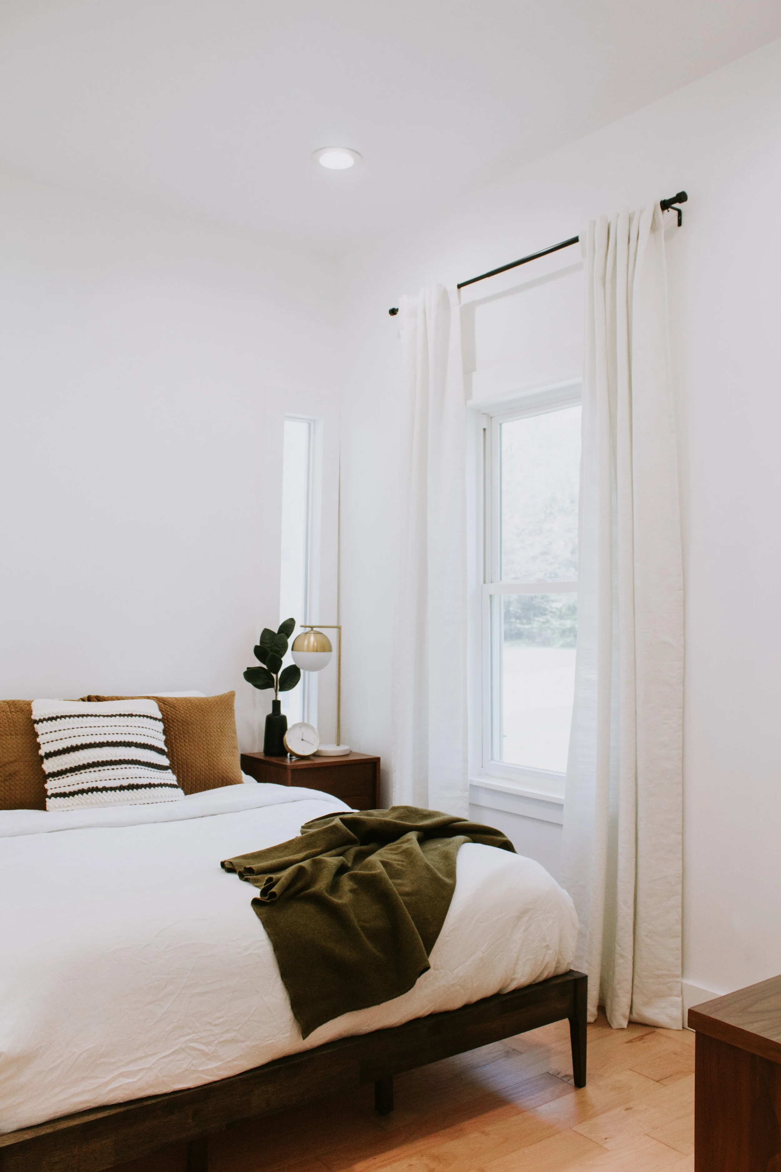 Home Office Makeover Reveal - our bedroom and office before and after transformation. We turned this basic room into an office oasis! Modern hunter green wainscoting, floor to ceiling curtains, and a waterfall desk. It's a modern office dream by Nad…