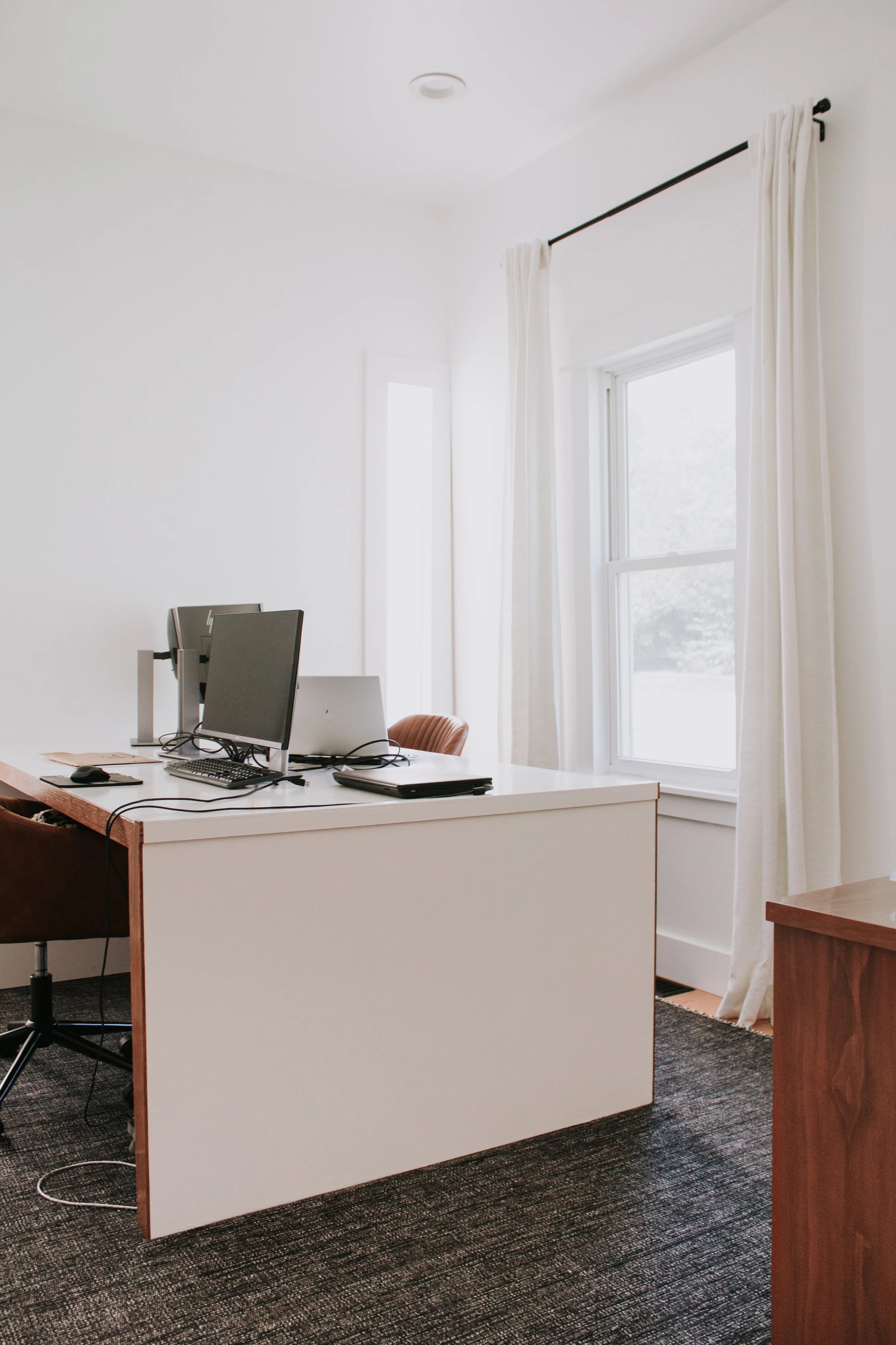 Home Office Makeover Reveal - our bedroom and office before and after transformation. We turned this basic room into an office oasis! Modern hunter green wainscoting, floor to ceiling curtains, and a waterfall desk. It's a modern office dream by Nad…