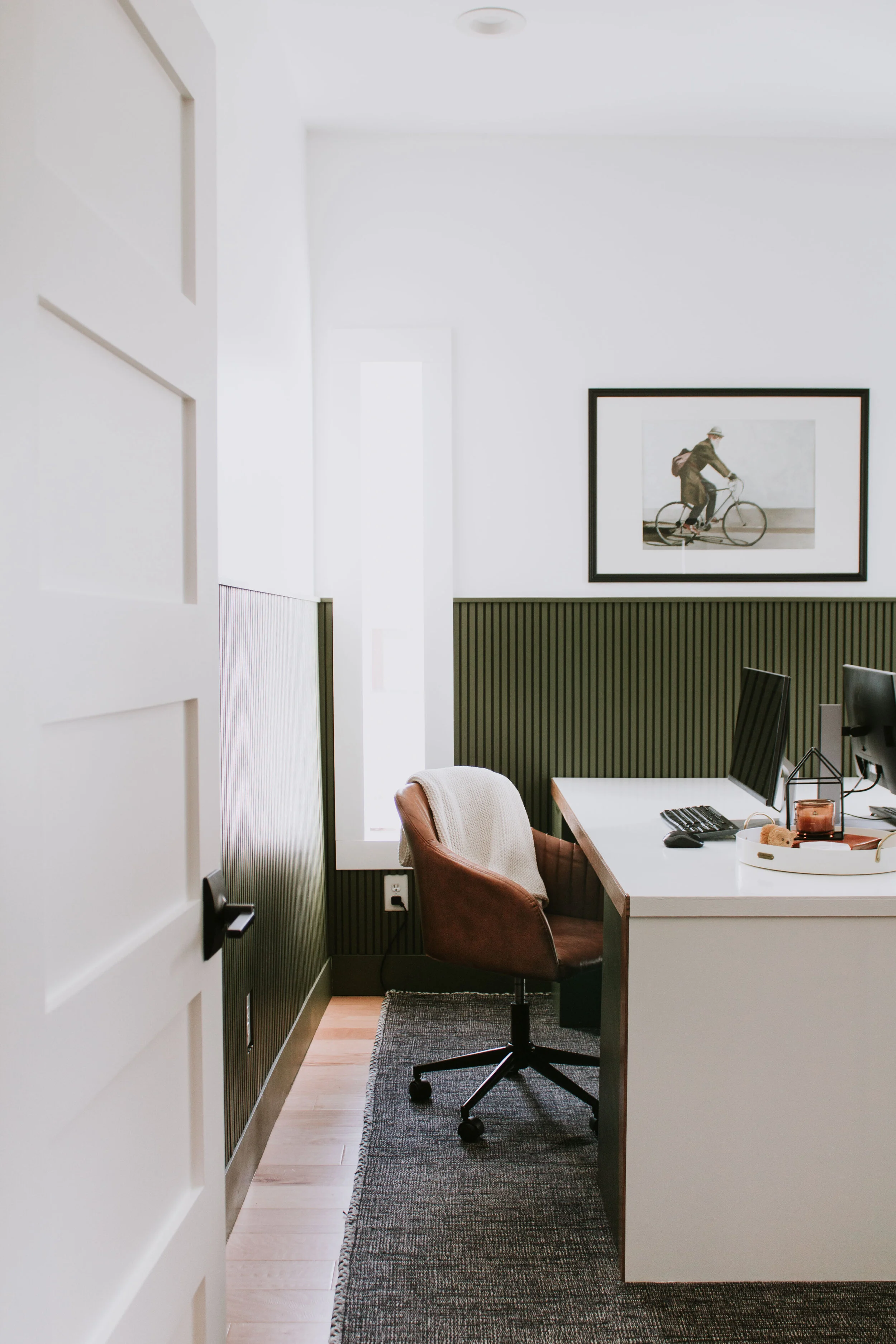 Home Office Makeover Reveal - our bedroom and office before and after transformation. We turned this basic room into an office oasis! Modern hunter green wainscoting, floor to ceiling curtains, and a waterfall desk. It's a modern office dream by Nad…