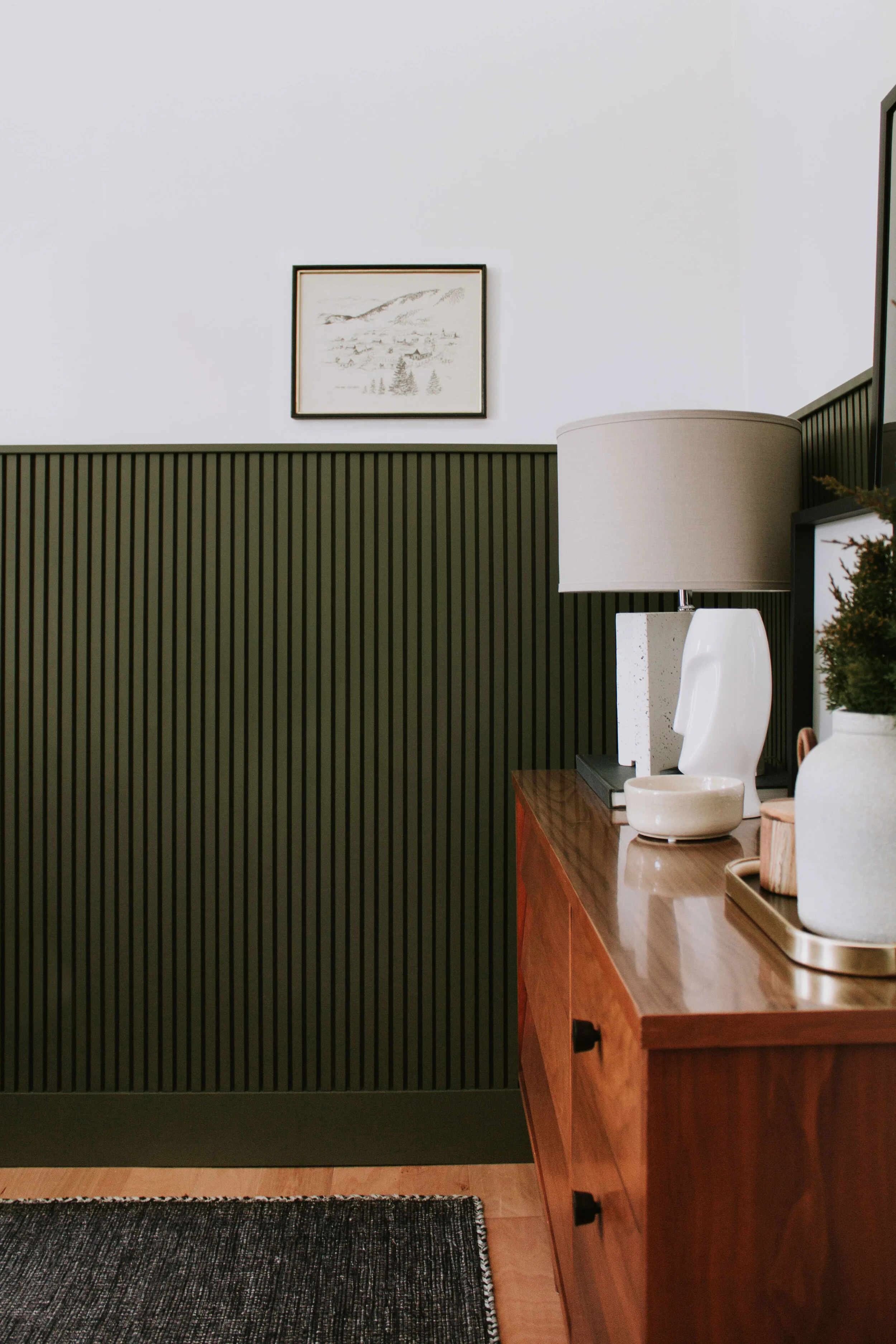 Home Office Makeover Reveal - our bedroom and office before and after transformation. We turned this basic room into an office oasis! Modern hunter green wainscoting, floor to ceiling curtains, and a waterfall desk. It's a modern office dream by Nad…