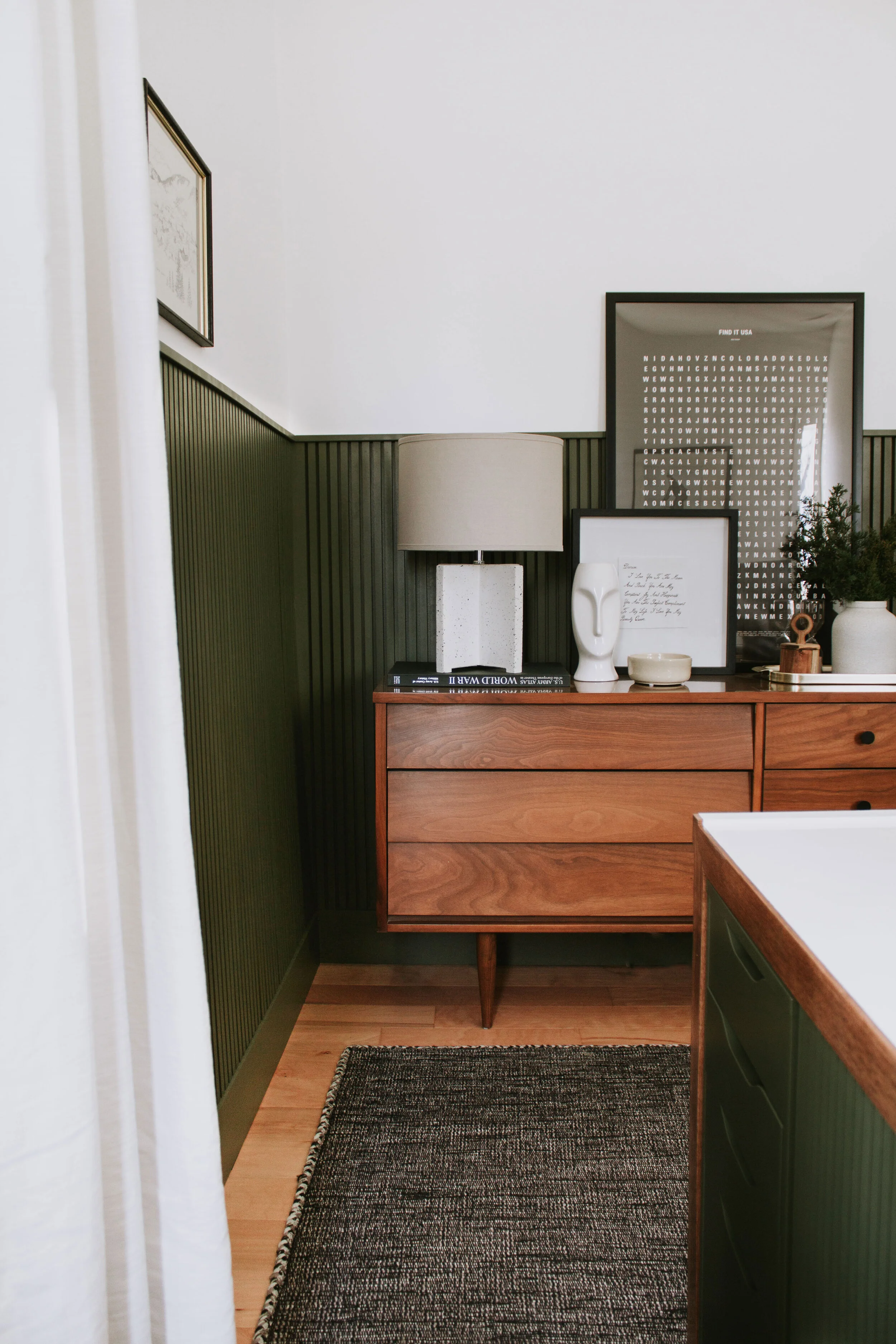 Home Office Makeover Reveal - our bedroom and office before and after transformation. We turned this basic room into an office oasis! Modern hunter green wainscoting, floor to ceiling curtains, and a waterfall desk. It's a modern office dream by Nad…