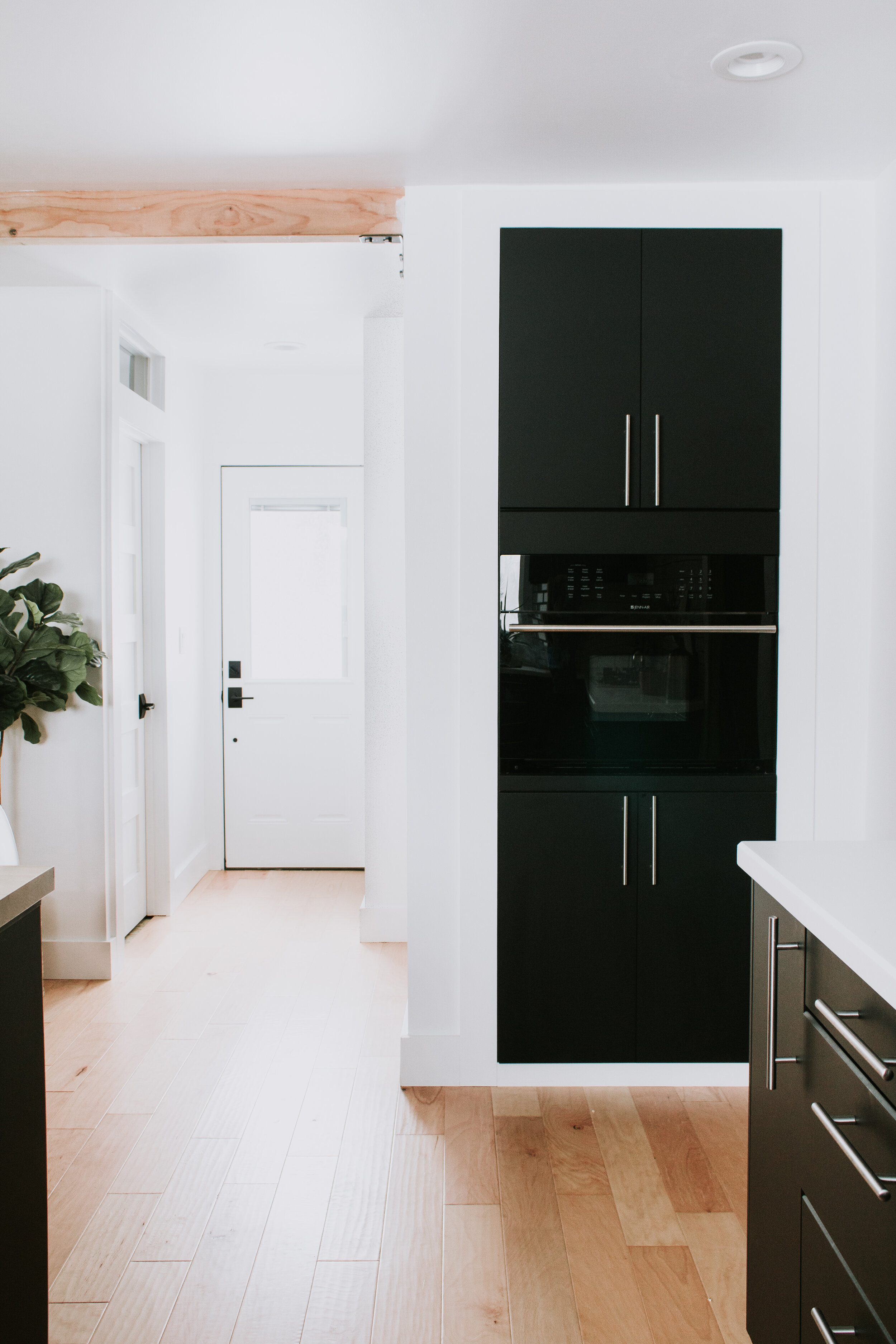 6 Home Features We Couldn't Live Without | Nadine Stay | Island with storage, a built in microwave, transom windows above interior doors, a slide out trash can, dimmer switches and mood lighting, a fireplace
