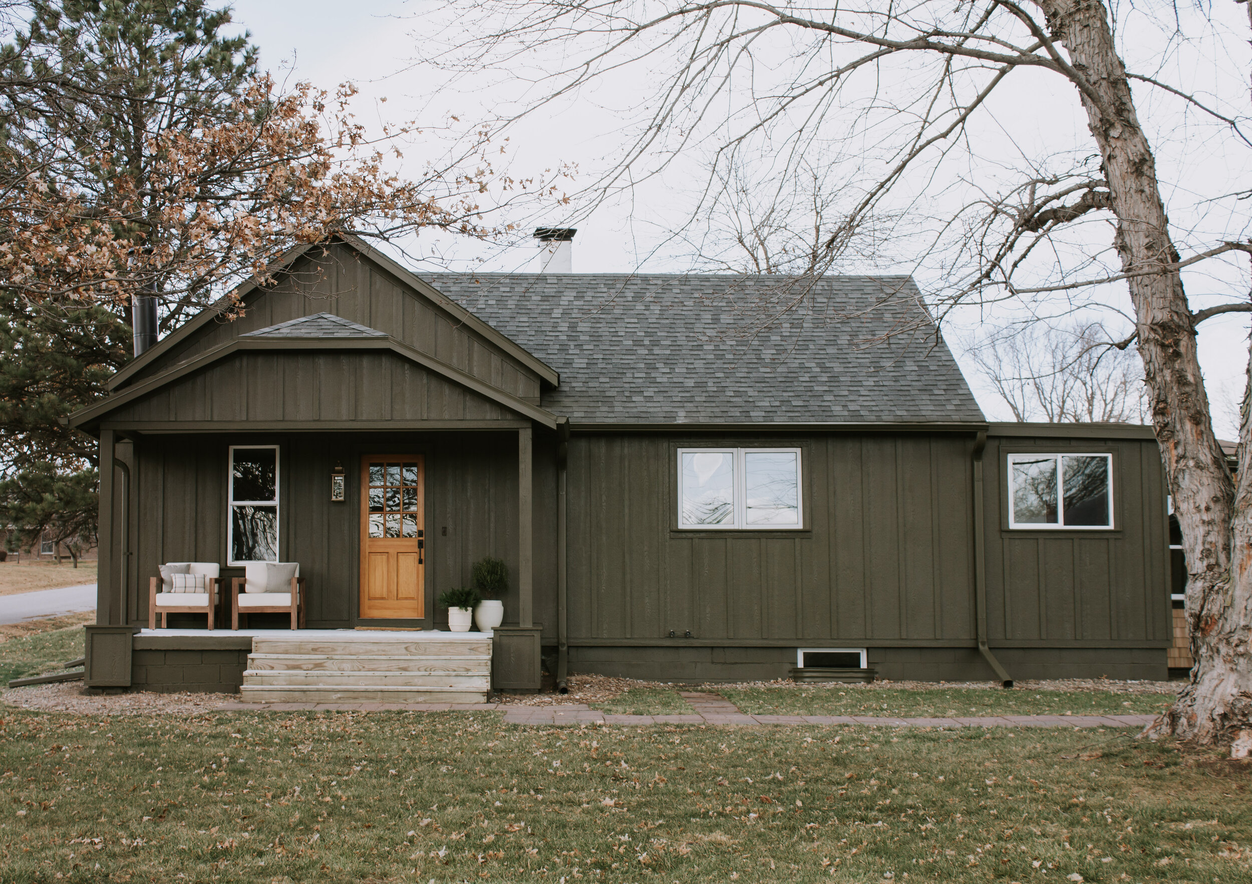 Our Home Exterior Reveal (Phase 1) | Exterior makeover and renovation. Home exterior before and after transformation. New board and batten siding and a cabin design style. Exterior paint color is Muddled Basil by Sherwin Williams | Nadine Stay