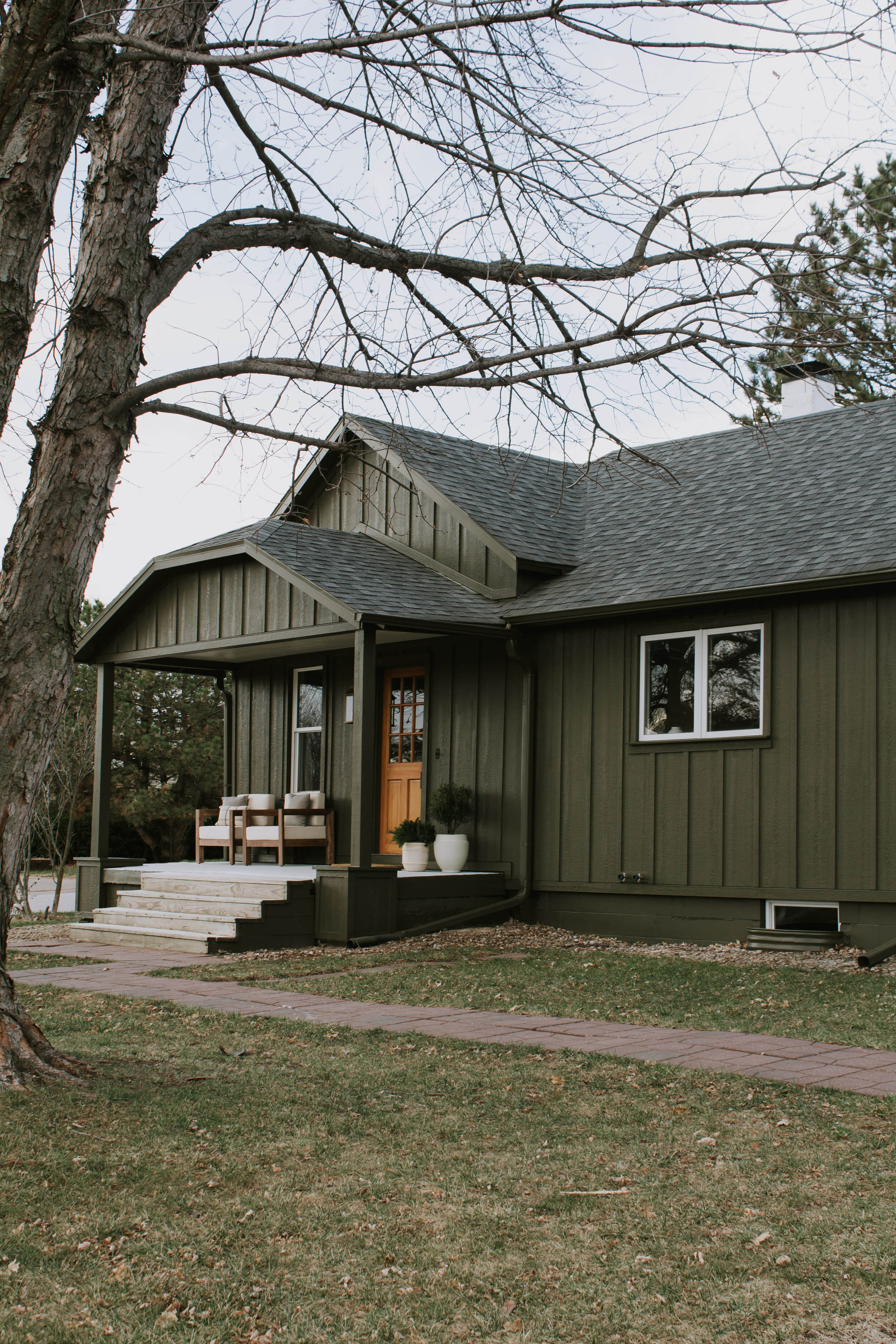 Our Home Exterior Reveal (Phase 1) | Exterior makeover and renovation. Home exterior before and after transformation. New board and batten siding and a cabin design style. Exterior paint color is Muddled Basil by Sherwin Williams | Nadine Stay