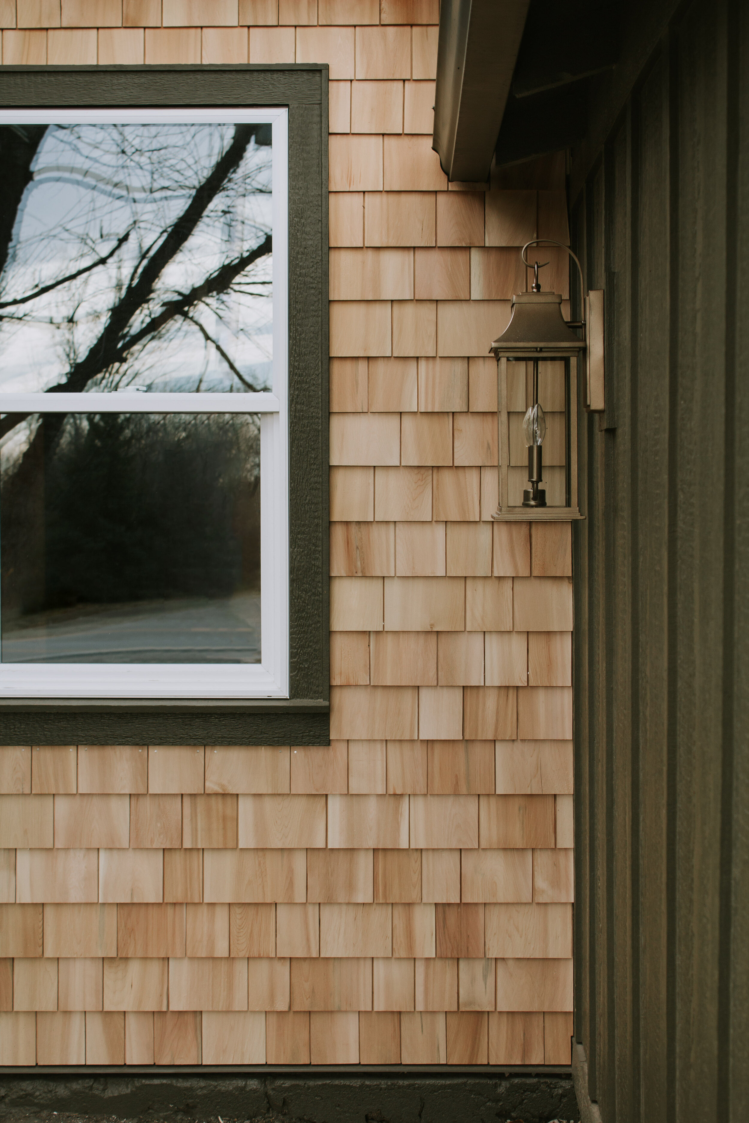 Our passthrough transformation + installing cedar shakes - Nadine Stay | Natural cedar shake shingles on our walkway between our house and garage. Replacing a door with a window. Home exterior before and after | Nadine Stay