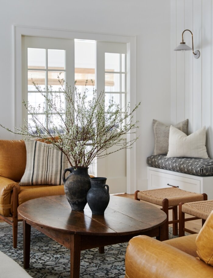 10 interior design styles, people, products, and trends I'm crushing on right now - rustic furniture and oval coffee tables. | Image via Amber Interiors and Tessa Neustadt