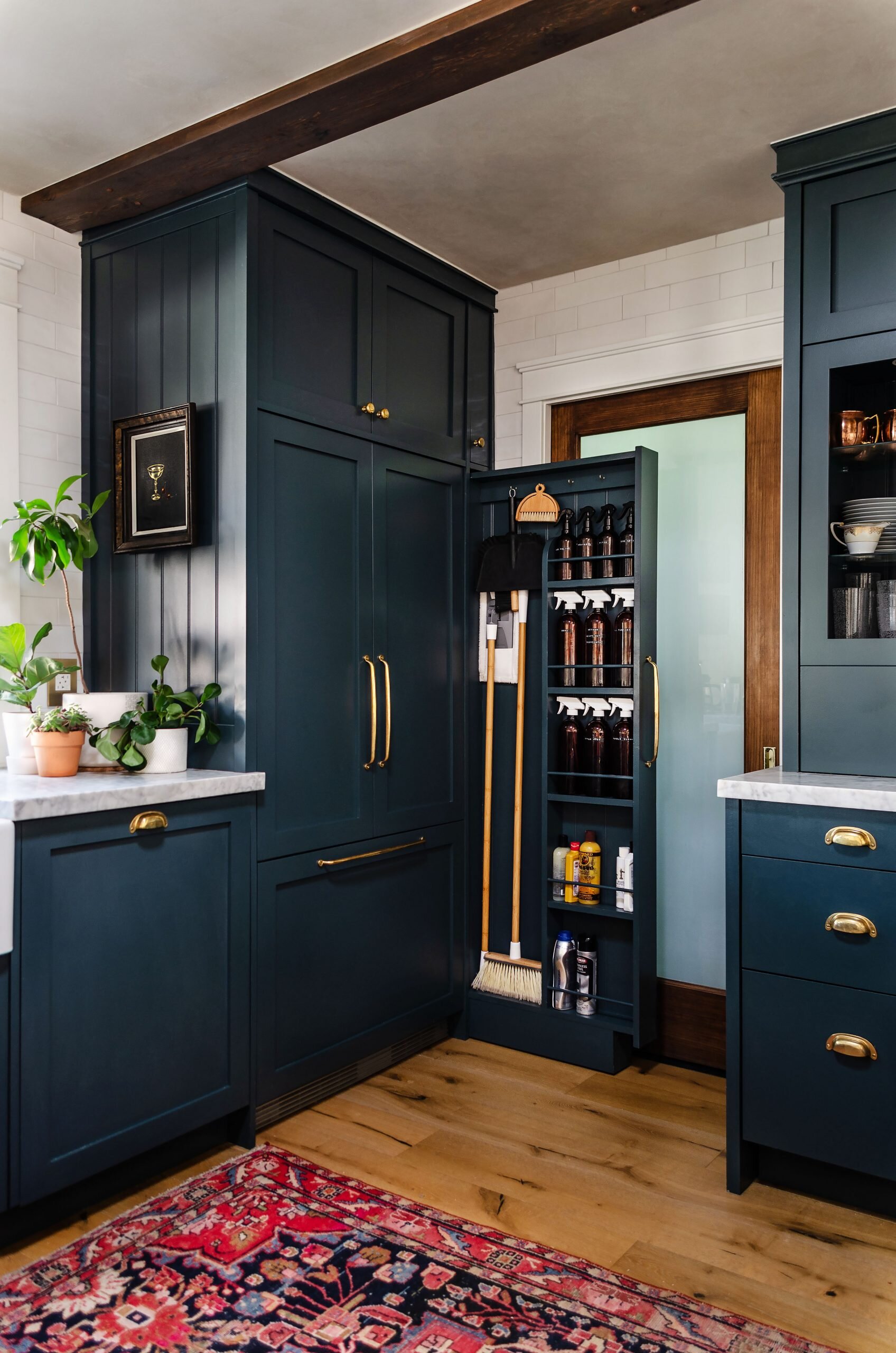 Pull out broom and cleaning cabinet in the kitchen. How to add a slim cleaning cabinet in the kitchen or laundry room. | Image via Renovate108