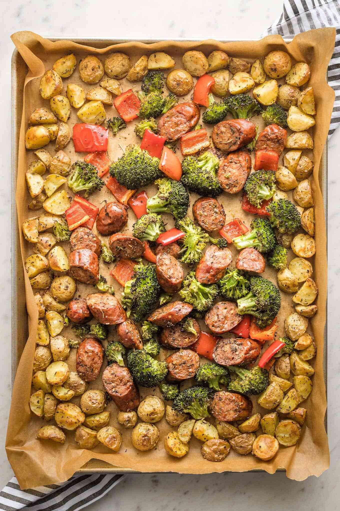 Easy dinner recipe. Sheet pan sausage, broccoli, potatoes, and red peppers. Recipe by Nourish & Fete. | Nadine Stay