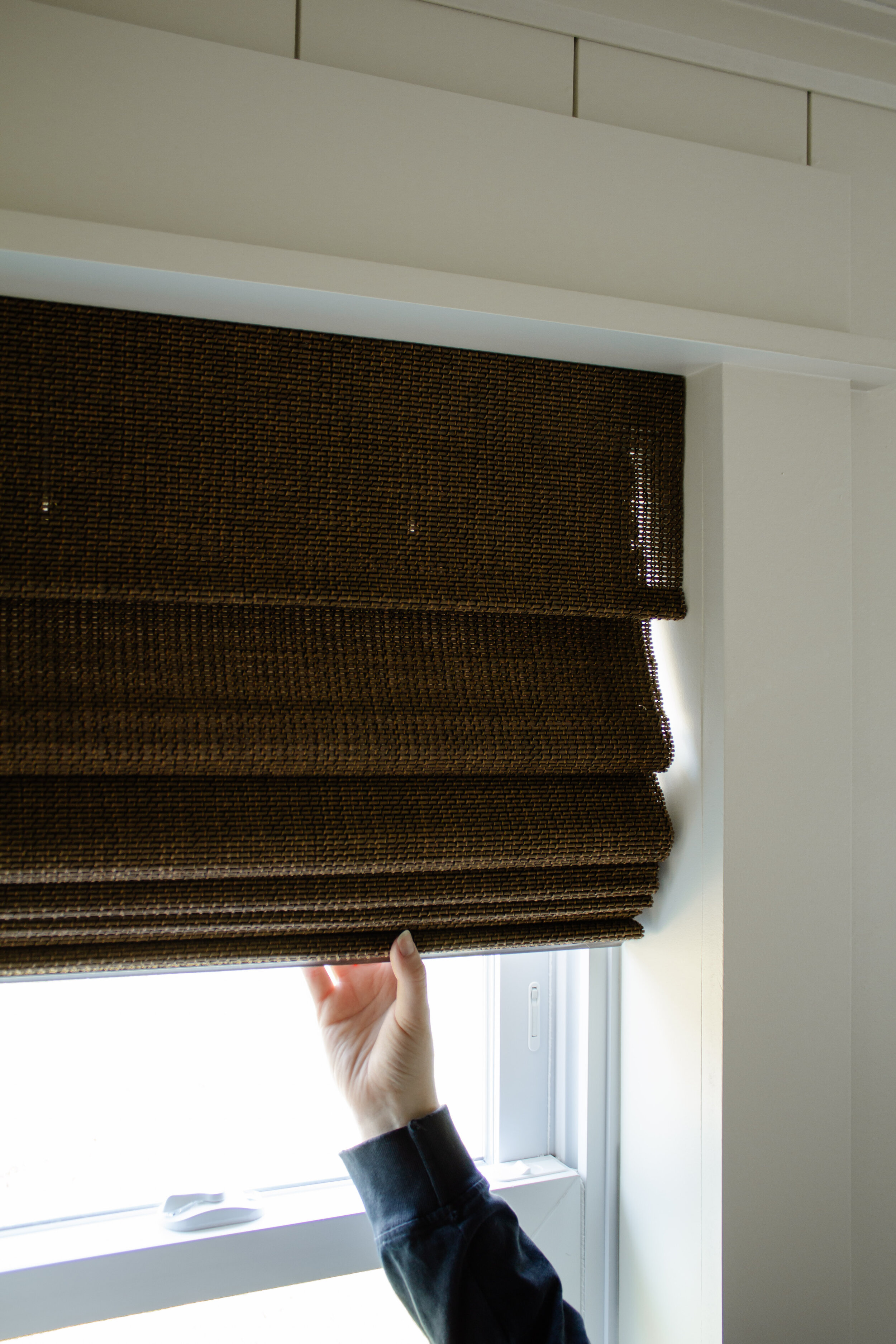 FAQ And Honest Review Of Our Bali Natural Woven Roman Shades | Nadine Stay - Where to buy custom blinds and shades. Natural wood woven shade in a dark brown color. Modern cabin bedroom styling and window covering tips.