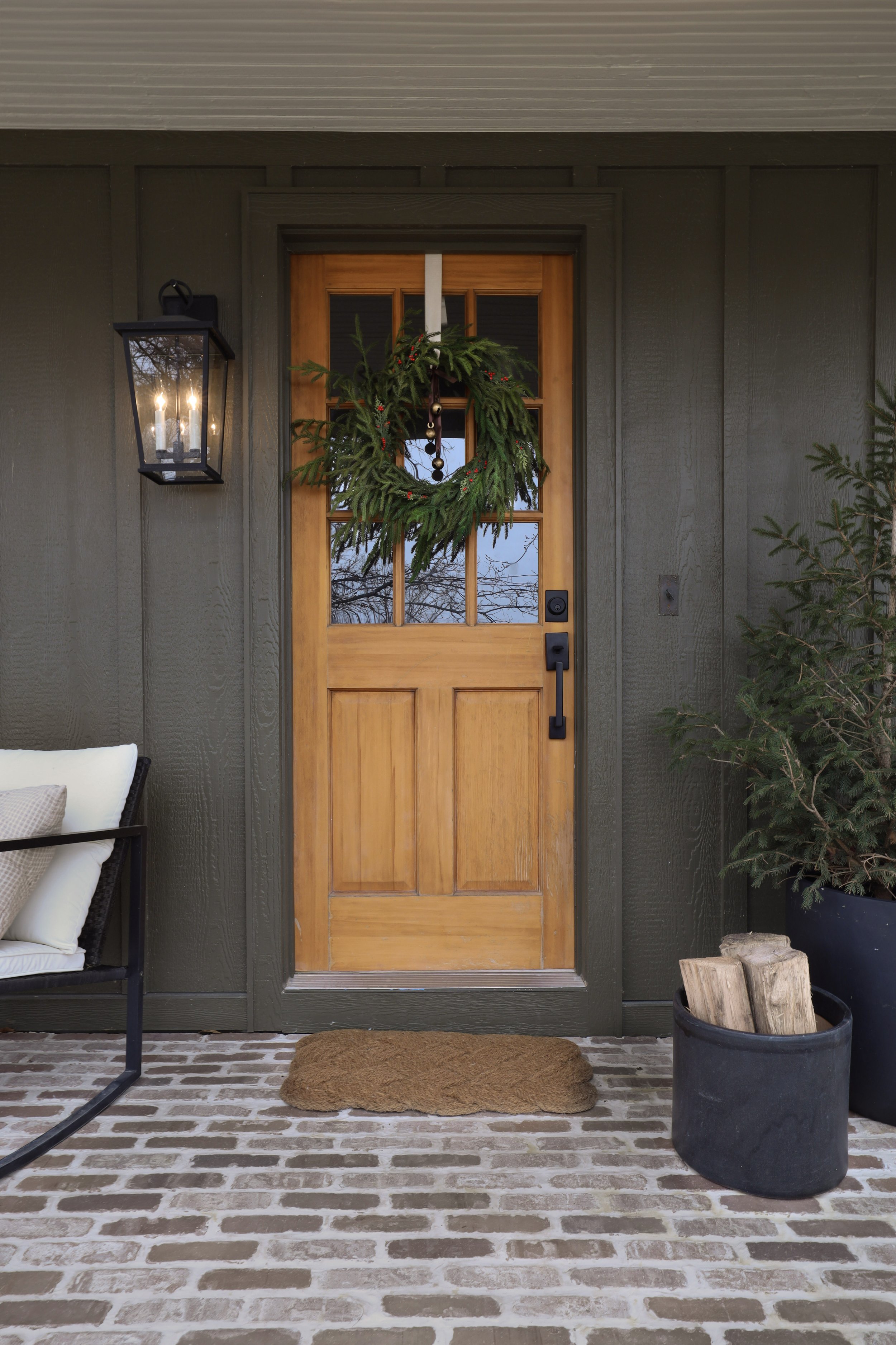 Porch before and after by Nadine Stay | Green exterior paint color. DIY porch brick floor. DIY flagstone path. DIY custom porch railing. Beige paint color for exterior. A craftsman porch railing. Box trim on porch railing posts.