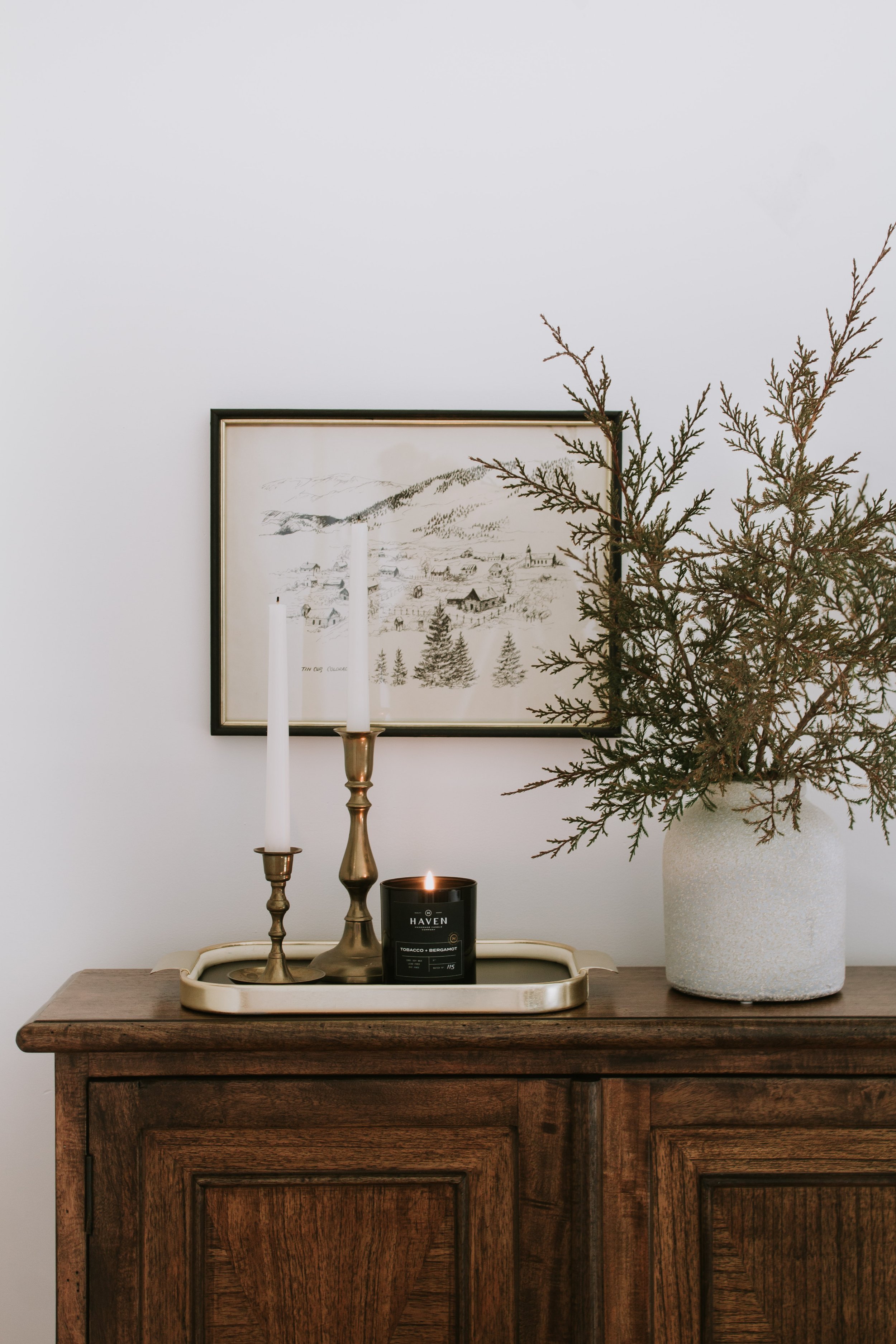 Top 12 Most Popular Posts - Subtle Christmas decor with a vintage mountain town sketch art, brass candlesticks, and juniper stems. | Nadine Stay