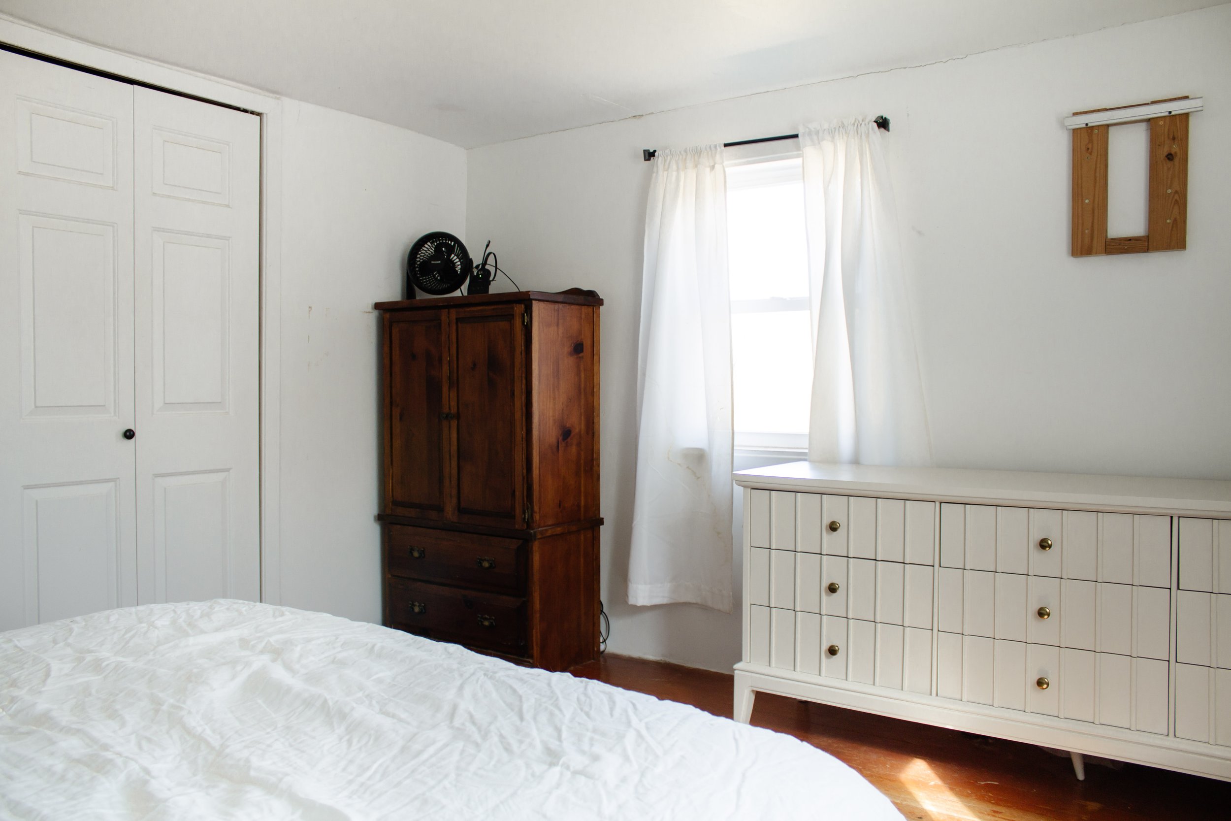 BEFORE | Primary bedroom remodel and makeover. How we turned our tiny bedroom with low ceilings into a cabin oasis. Wood plank ceiling. Vertical shiplap vertical plank walls. Cabin bedroom. California casual bedroom. Bifold door makeover. Nadine Stay