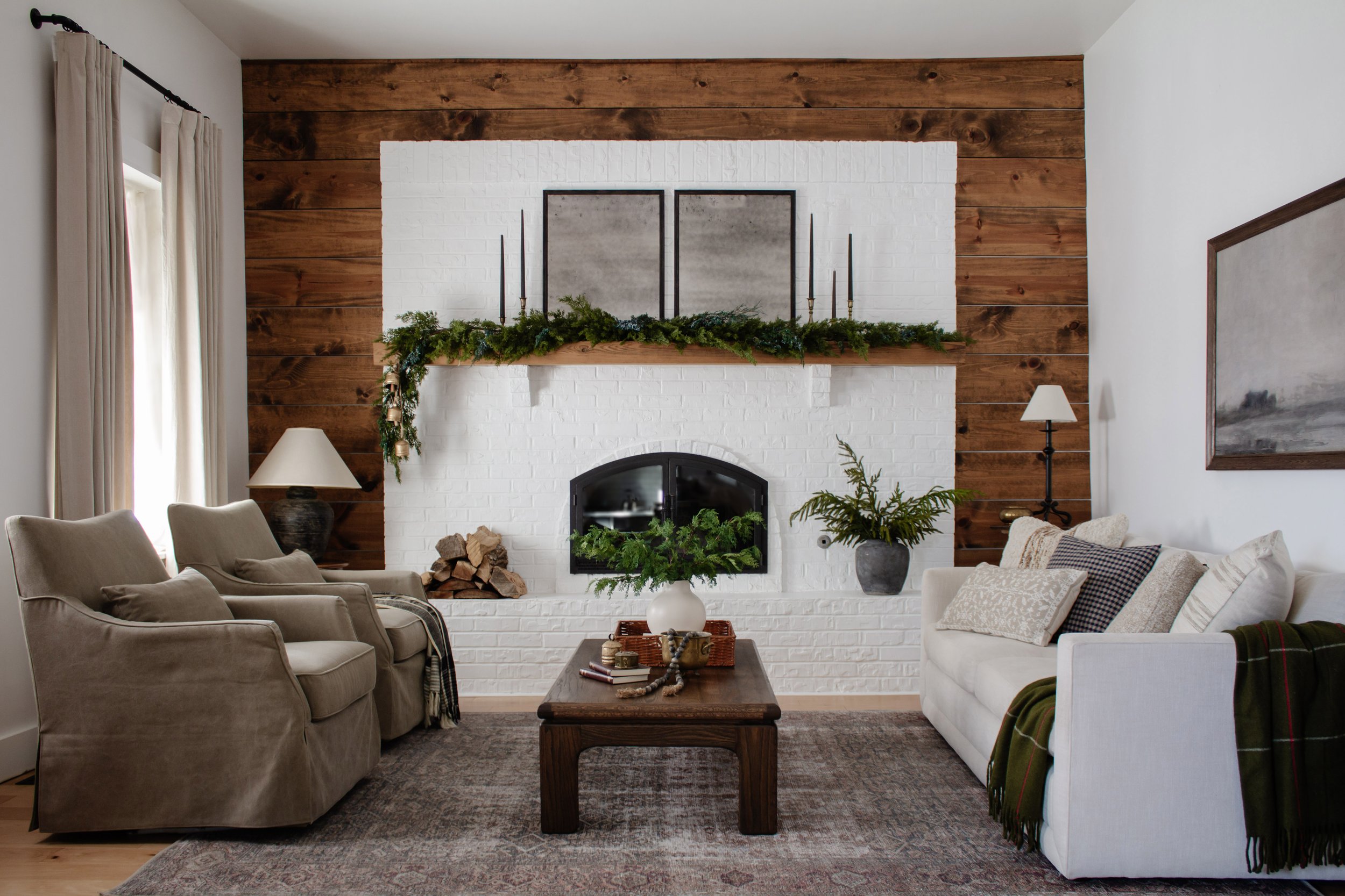 Cozy living room Christmas decorations. Holiday decor inspiration. Paint white brick fireplace. Mantel decor. Faux garland under $80. | Nadine Stay