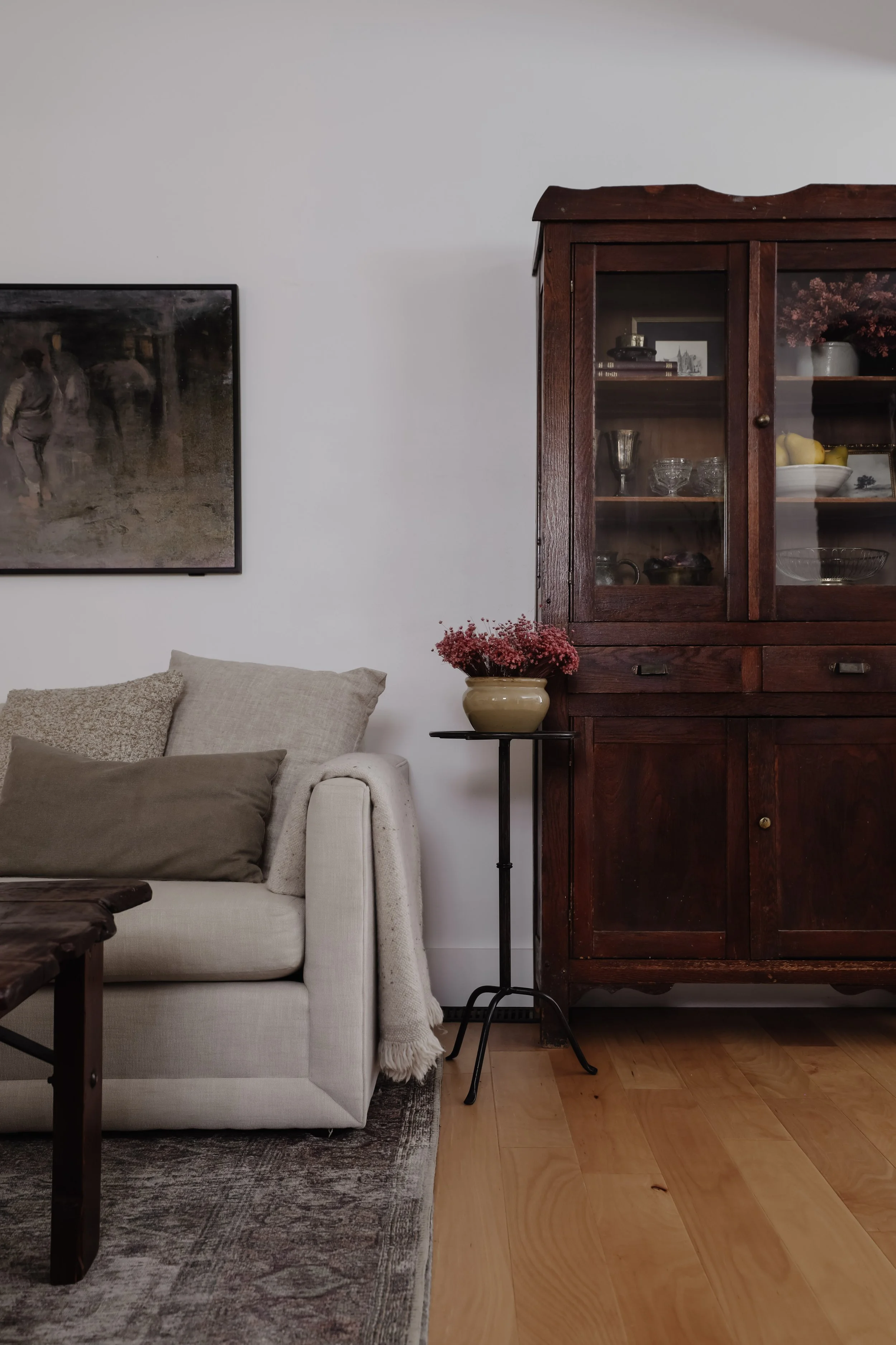 A subtle interior design trend I'm fully on board with - martini tables. 9 small and skinny drink tables that I like. Black, brass, and wood round side tables. Living room styling with antique hutch and ivory Maiden Home sofa. | Nadine Stay