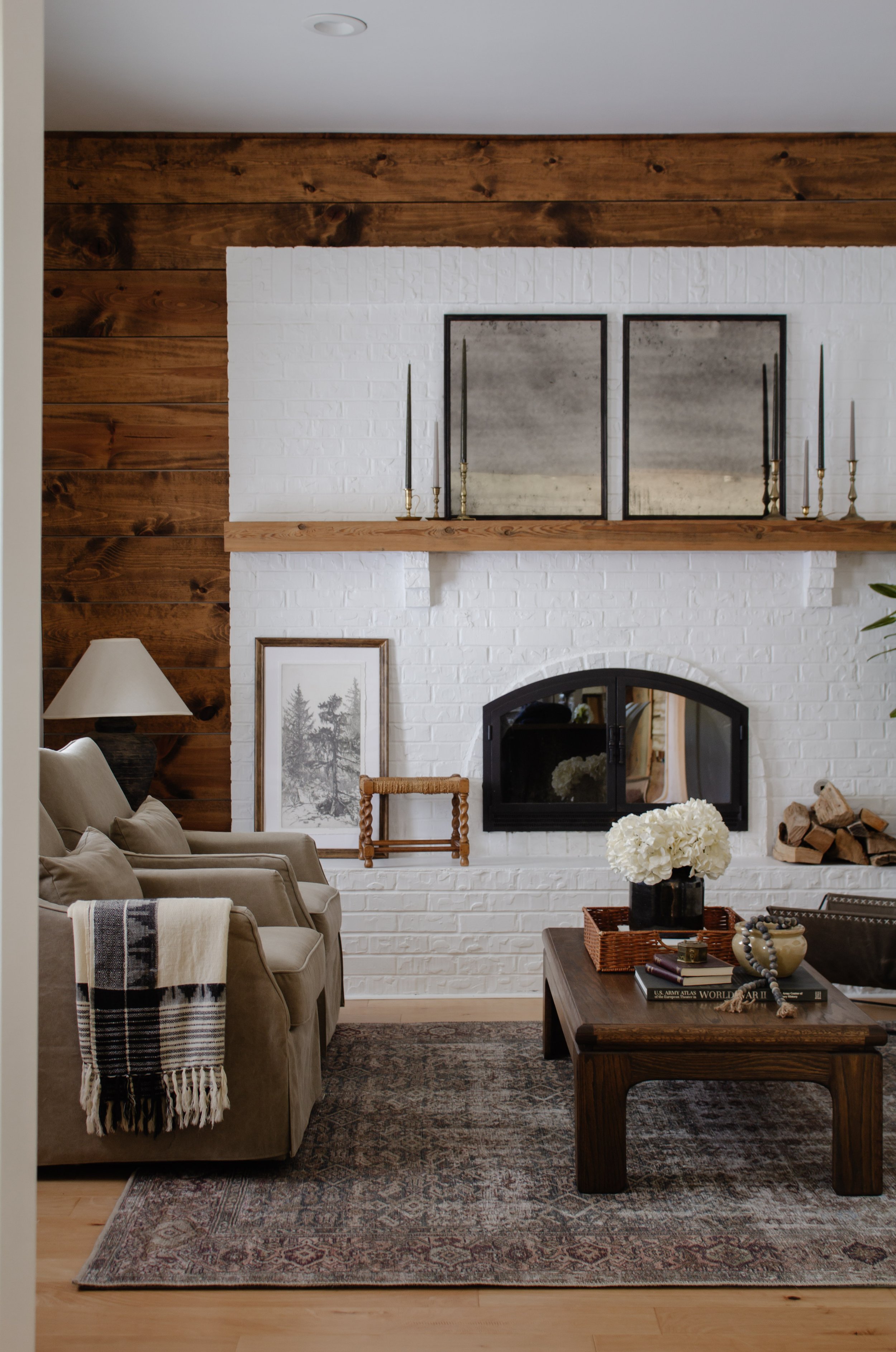 Living Room Refresh Reveal - Nadine Stay | How we gave our living room a cabin inspired makeover. Elevated California Casual cabin living room design. Brick fireplace with a wood wall. Cozy living room decorating ideas. | Nadine Stay