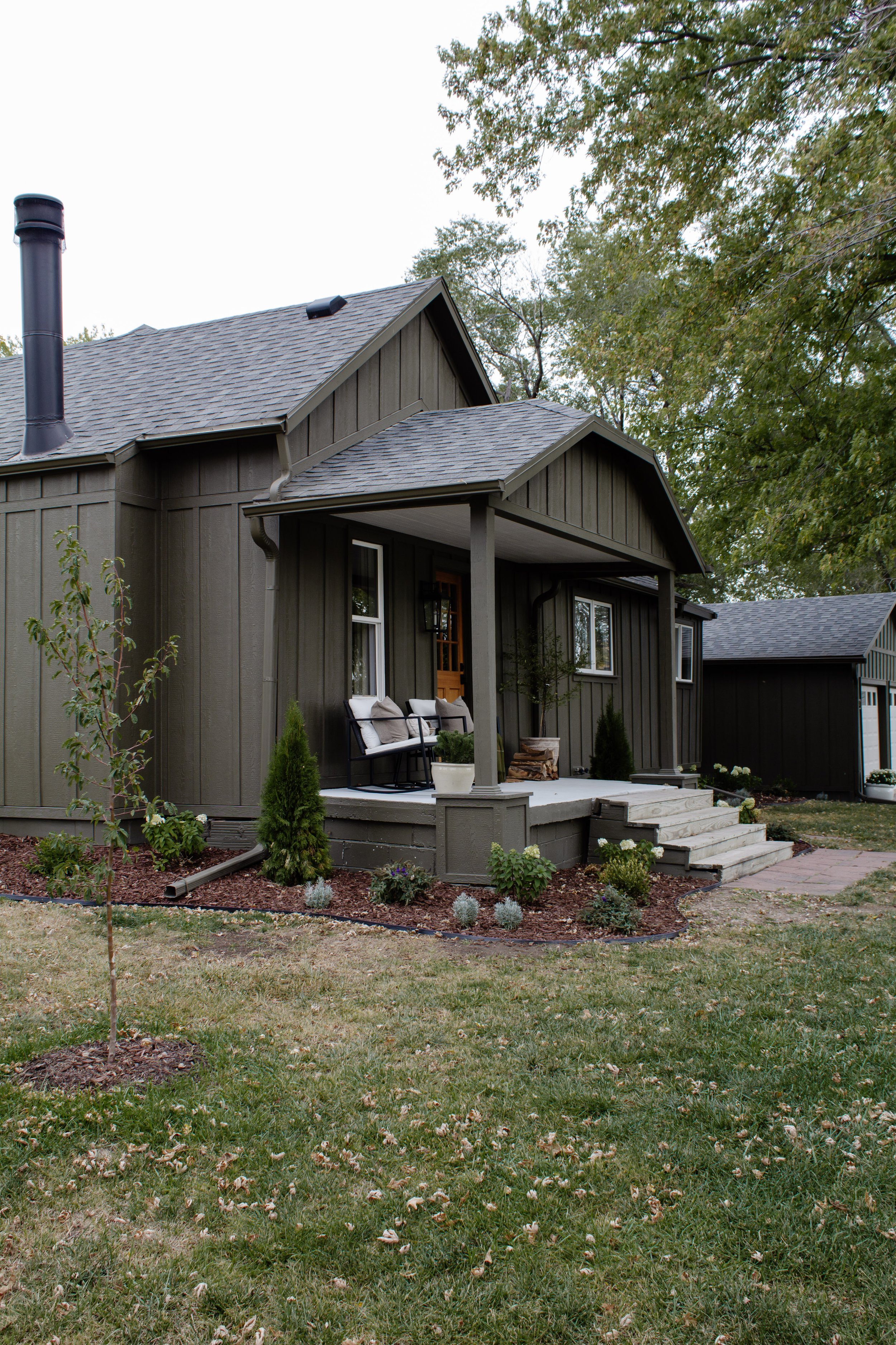 Our Landscaping Reveal - Nadine Stay | Our front elevation landscape plans. The plants we chose. Hydrangeas, lavender, boxwood, & pugster blue bush. Mulch & landscape edging we love. Cabin inspired exterior. Muddled Basil by Sherwin Williams