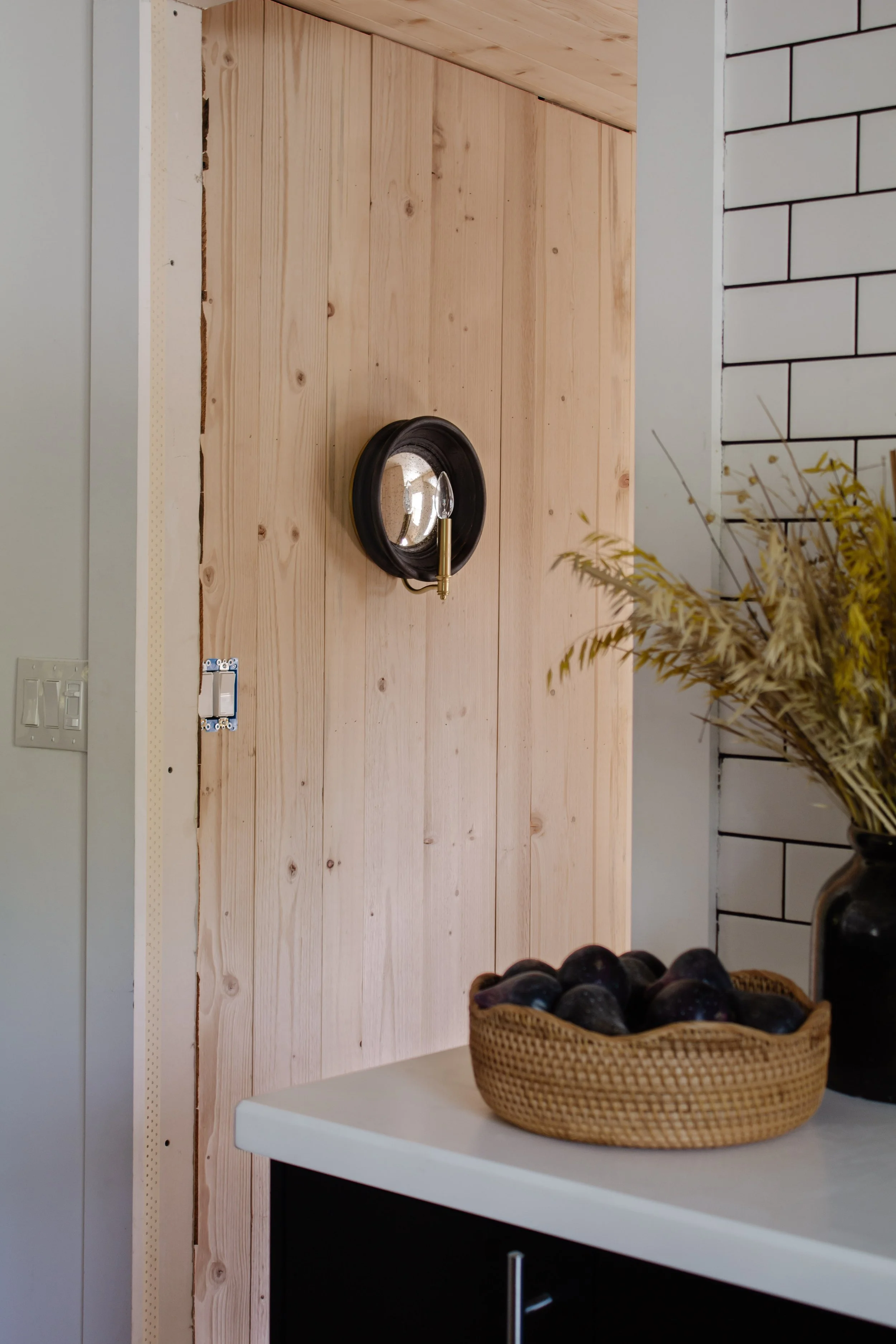 Laundry room lighting in progress. Round black framed mirror candle sconce under $300. Vintage looking wall sconces. Kitchen styling. Wood plank wall. | Nadine Stay