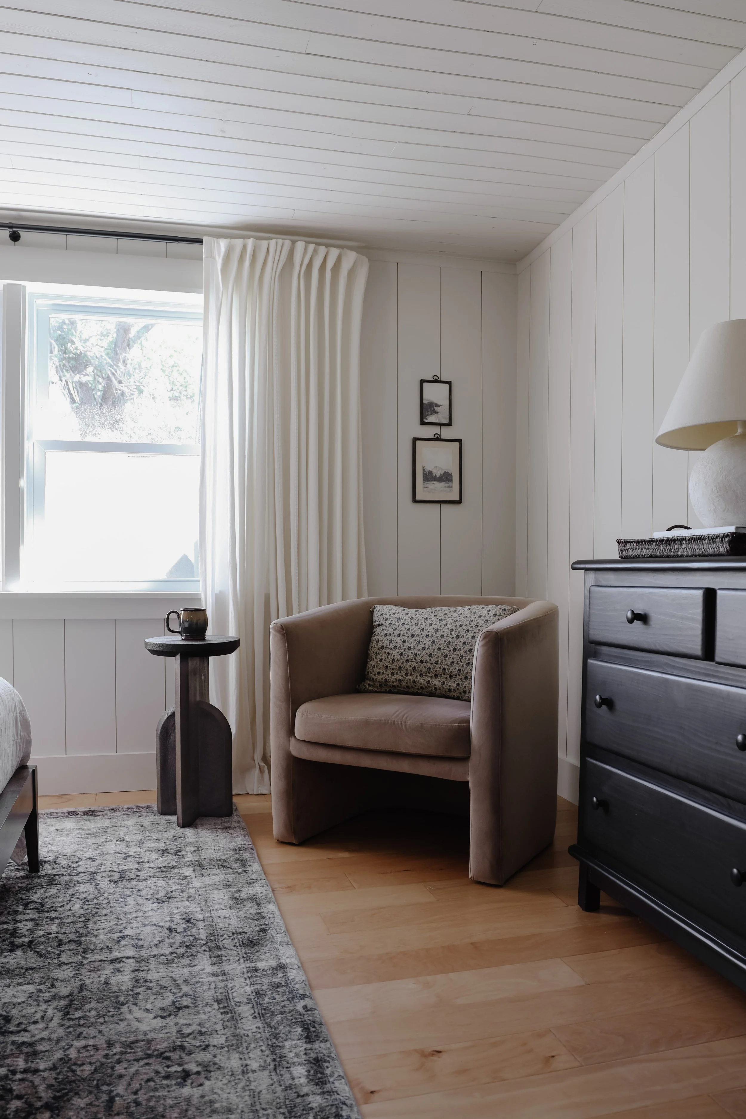 A subtle interior design trend I'm fully on board with - martini tables. 9 small and skinny drink tables that I like. Black, brass, and wood round side tables. Corner sitting area in bedroom. Brown velvet barrel chair and black dresser. | Nadine Stay