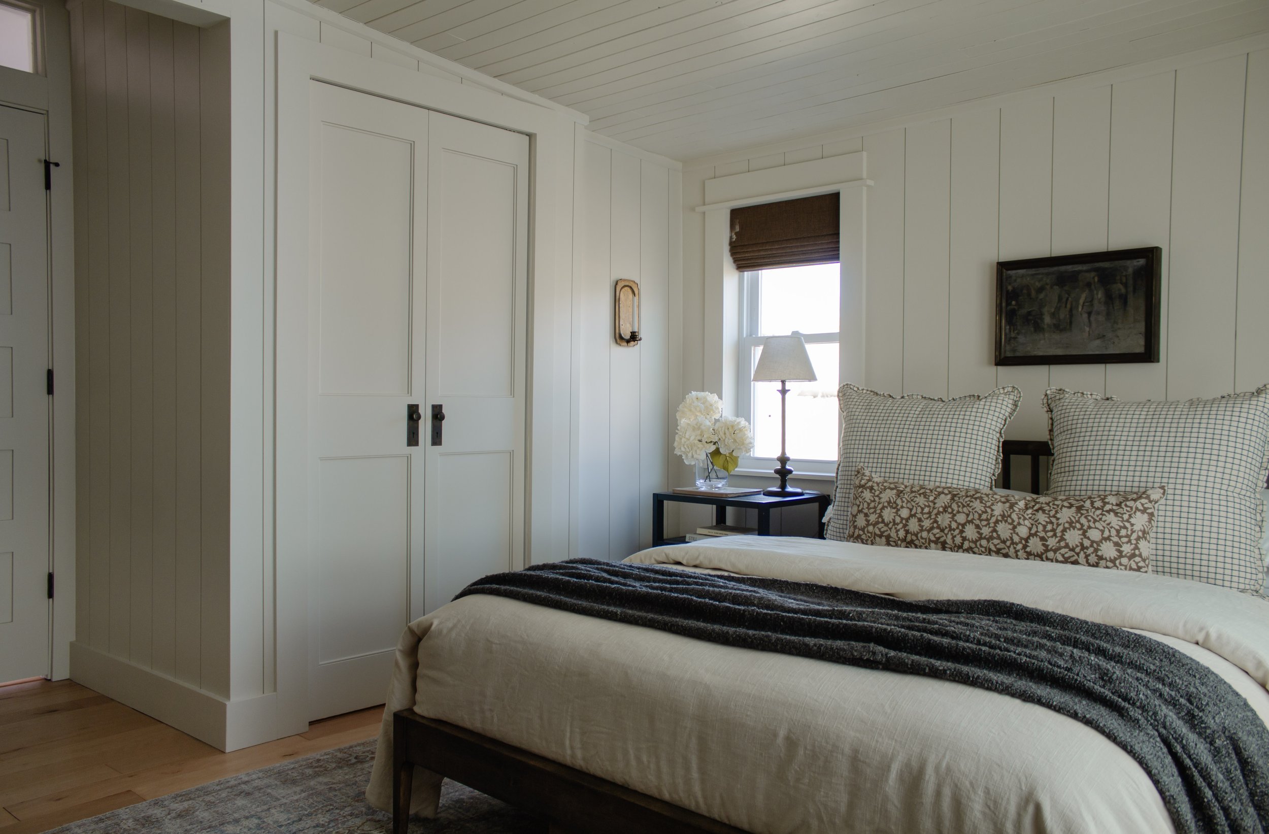 Primary bedroom remodel and makeover. How we turned our tiny bedroom with low ceilings into a cabin oasis. Wood plank ceiling. Vertical shiplap vertical plank walls. Cabin bedroom. California casual bedroom. Bifold door makeover. Nadine Stay