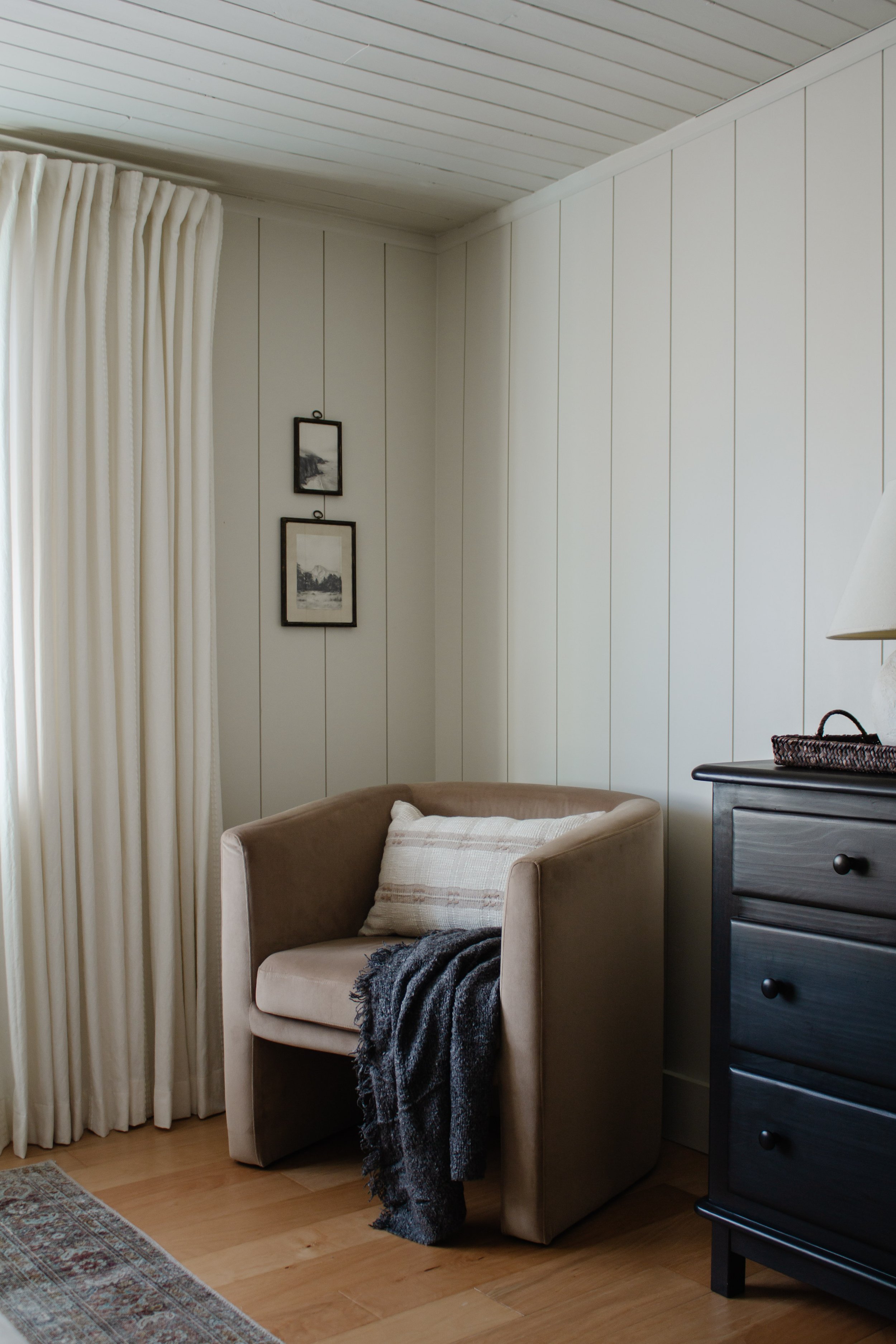 Primary bedroom remodel and makeover. How we turned our tiny bedroom with low ceilings into a cabin oasis. Wood plank ceiling. Vertical shiplap vertical plank walls. Cabin bedroom. California casual bedroom. Ivory curtains & barrel chair. Nadine Stay