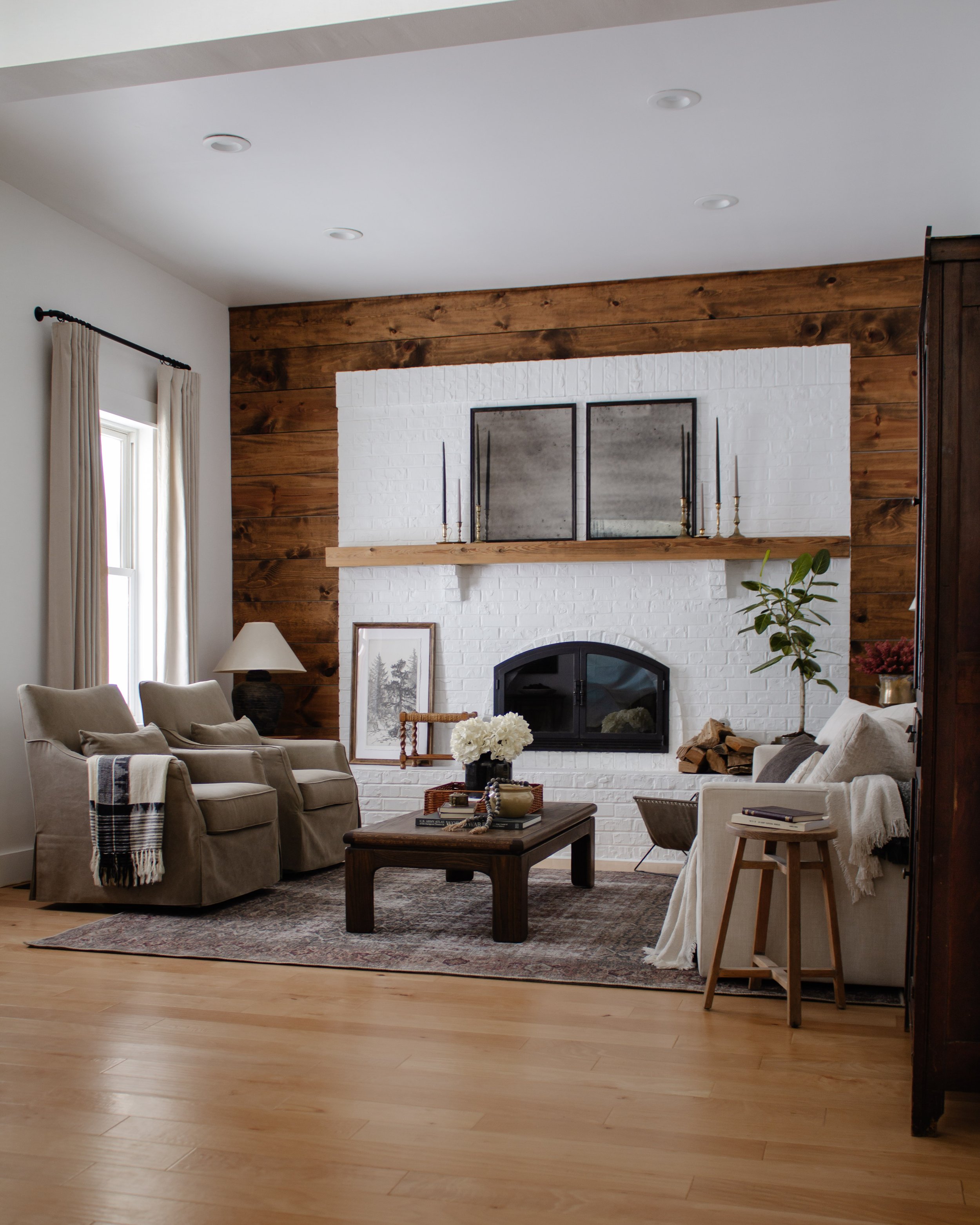 Living Room Refresh Reveal - Nadine Stay | How we gave our living room a cabin inspired makeover. Elevated California Casual cabin living room design. Brick fireplace with a wood wall. Cozy living room decorating ideas. | Nadine Stay