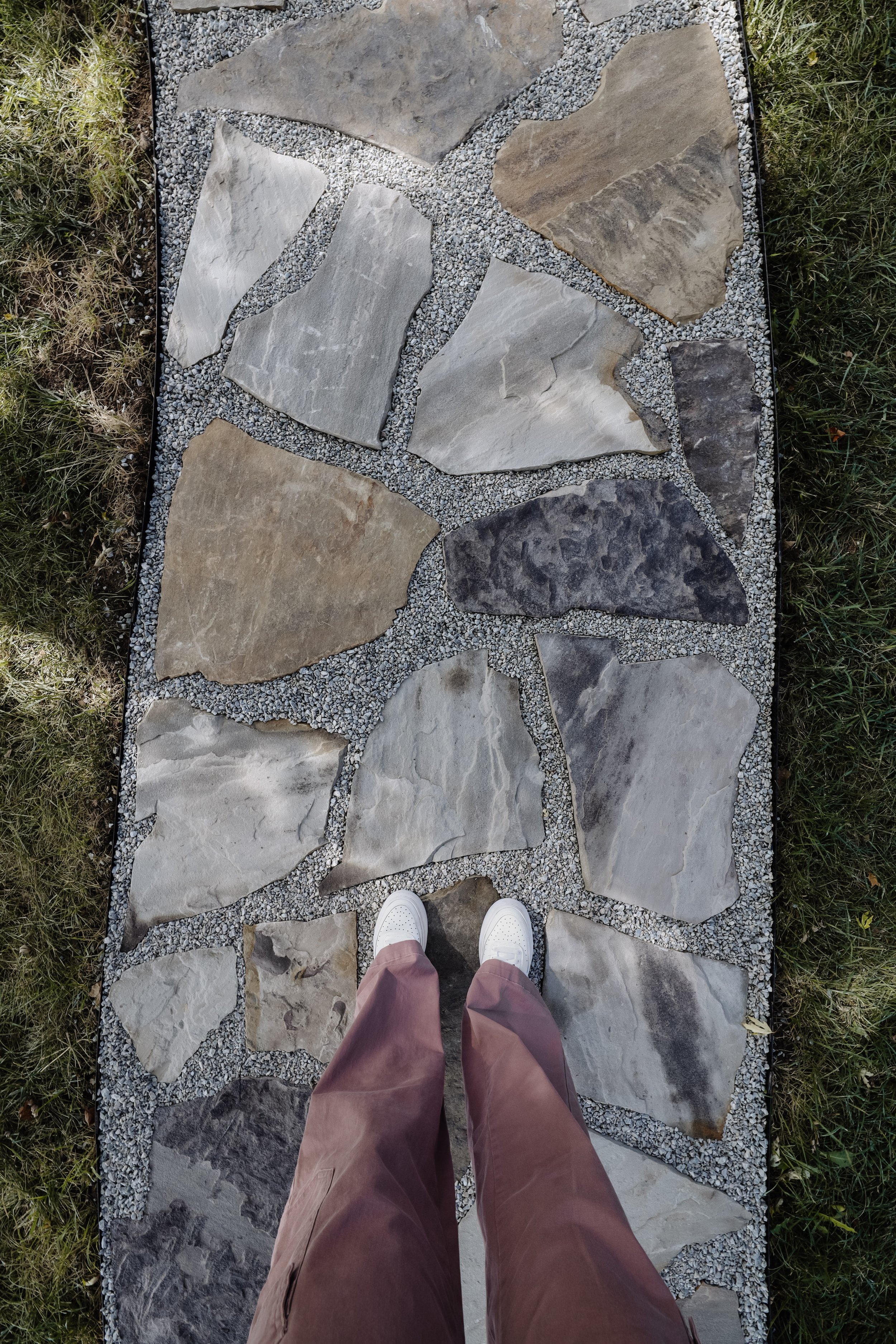Our flagstone path to our front porch. How to install a flagstone path to your house. How to glue pea gravel path so it doesn't scatter. Organic shaped flagstone path with limestone chips. Blue and orange flagstones. | Nadine Stay