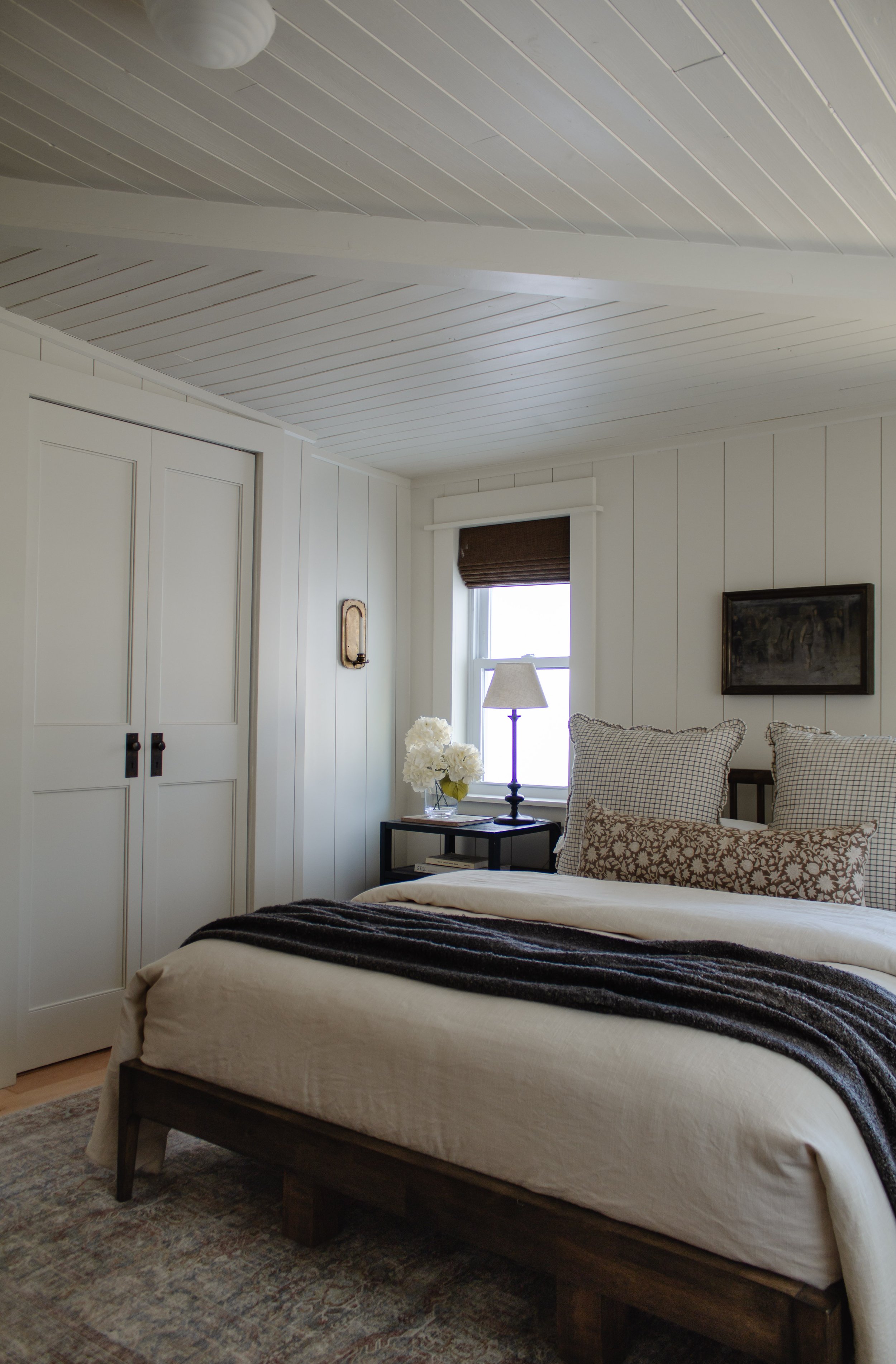 Primary bedroom remodel and makeover. How we turned our tiny bedroom with low ceilings into a cabin oasis. Wood plank ceiling. Vertical shiplap vertical plank walls. Cabin bedroom. California casual bedroom. Bifold door makeover. Nadine Stay