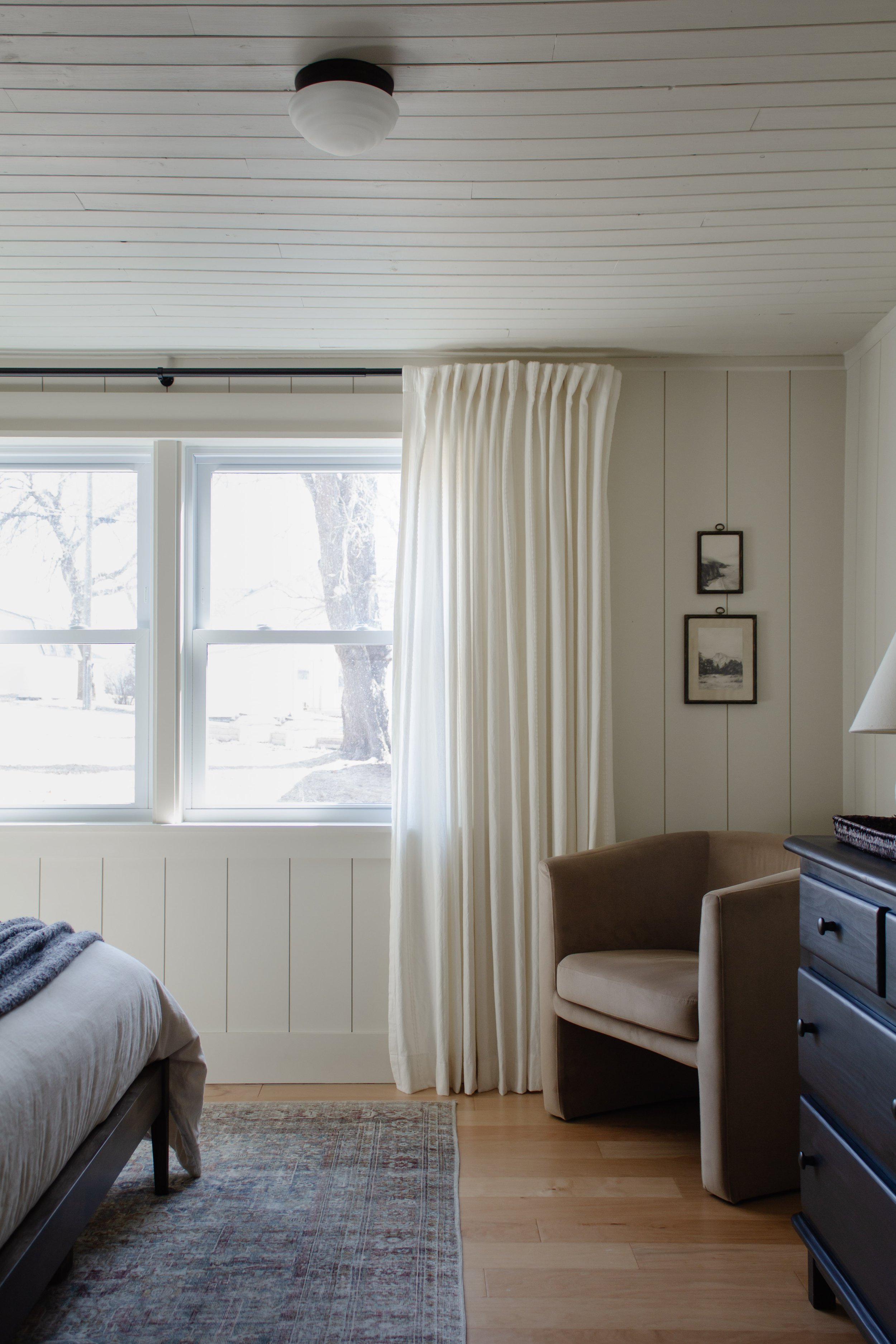 Primary bedroom remodel and makeover. How we turned our tiny bedroom with low ceilings into a cabin oasis. Wood plank ceiling. Vertical shiplap vertical plank walls. Cabin bedroom. California casual bedroom. Ivory curtains & barrel chair. Nadine Stay