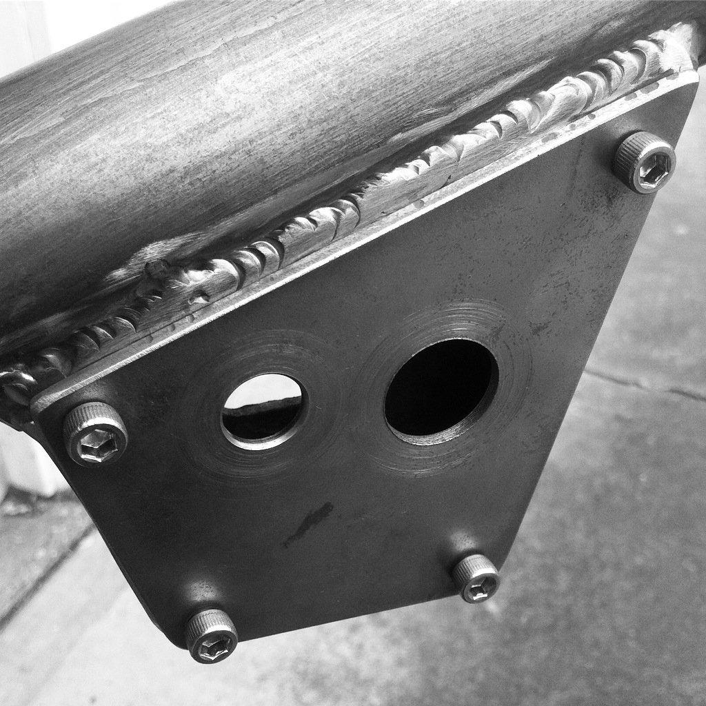  Ignition switch and starter button box built into the top motor mount on a chopper frame.  A small detail, but one that serves several functions while keeping a low profile.  A subtle element on a not-so-subtle bike. 