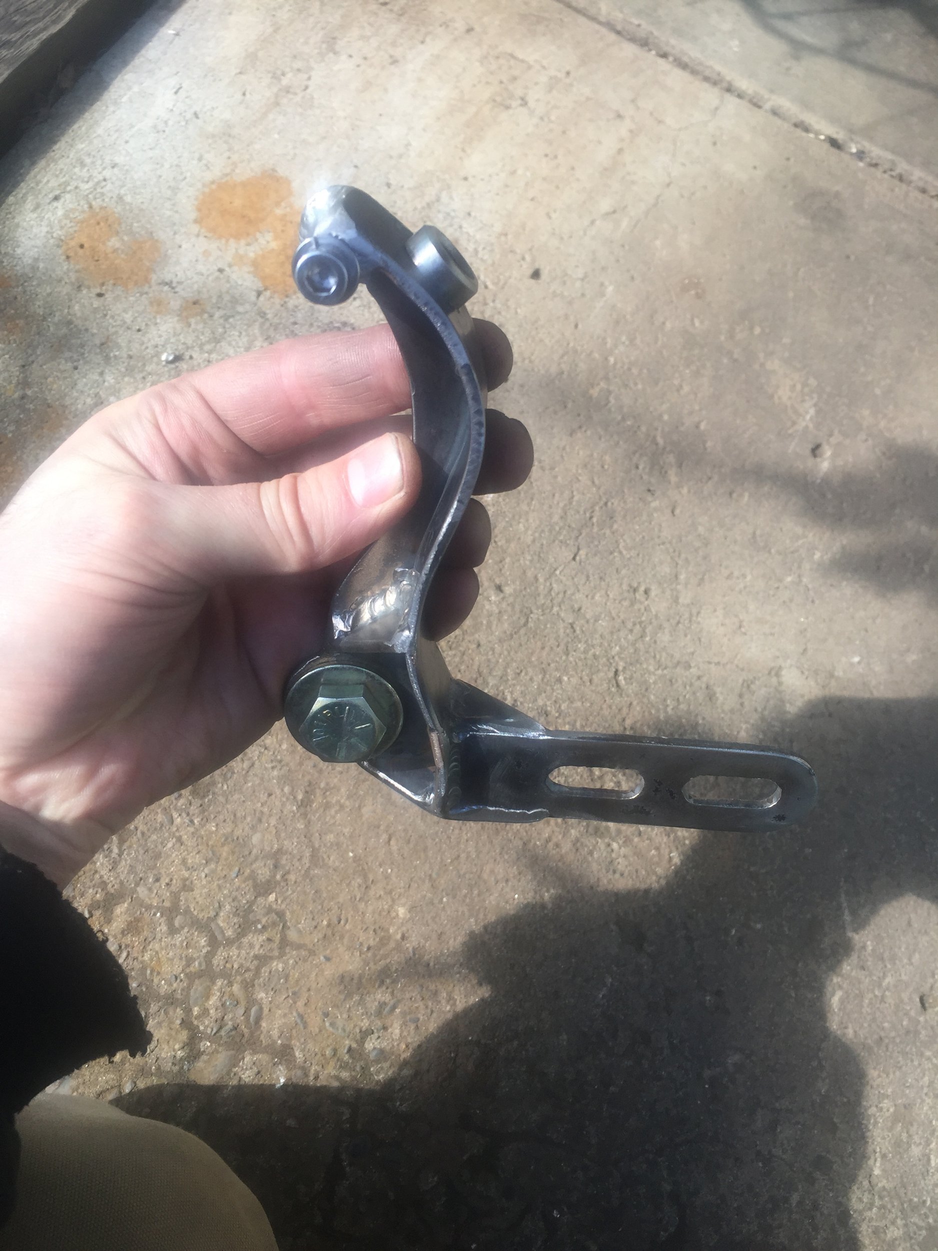  This weird looking little item serves several purposes.  It’s a chain guard, an exhaust mount, and it has a NPT brass oil fitting for the crankcase oil breather, oiling the chain with any oil mist from the case. 