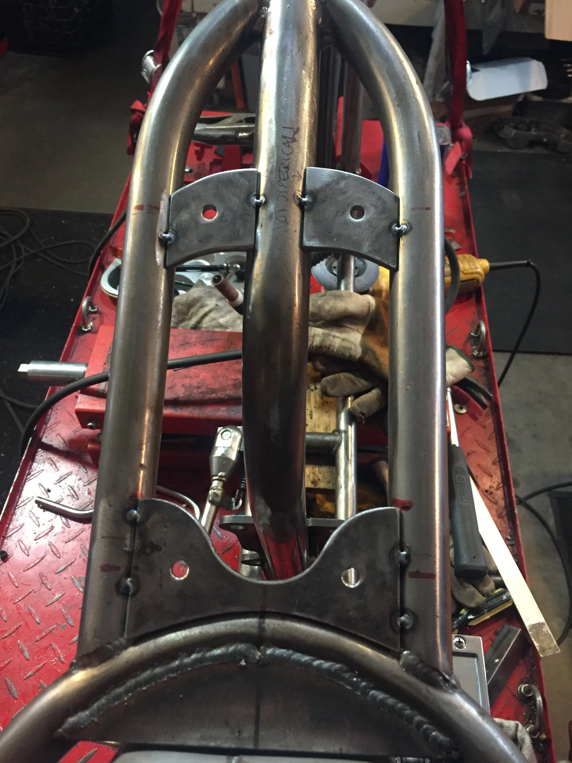  Top view of the Ironhead frame with the frame mounts tacked in.  You can see how skinny that frame is.  The holes are for rubber isolator mounts that will thread into bungs in the top of the oil tank.  Not a lot of wiggle room here. 