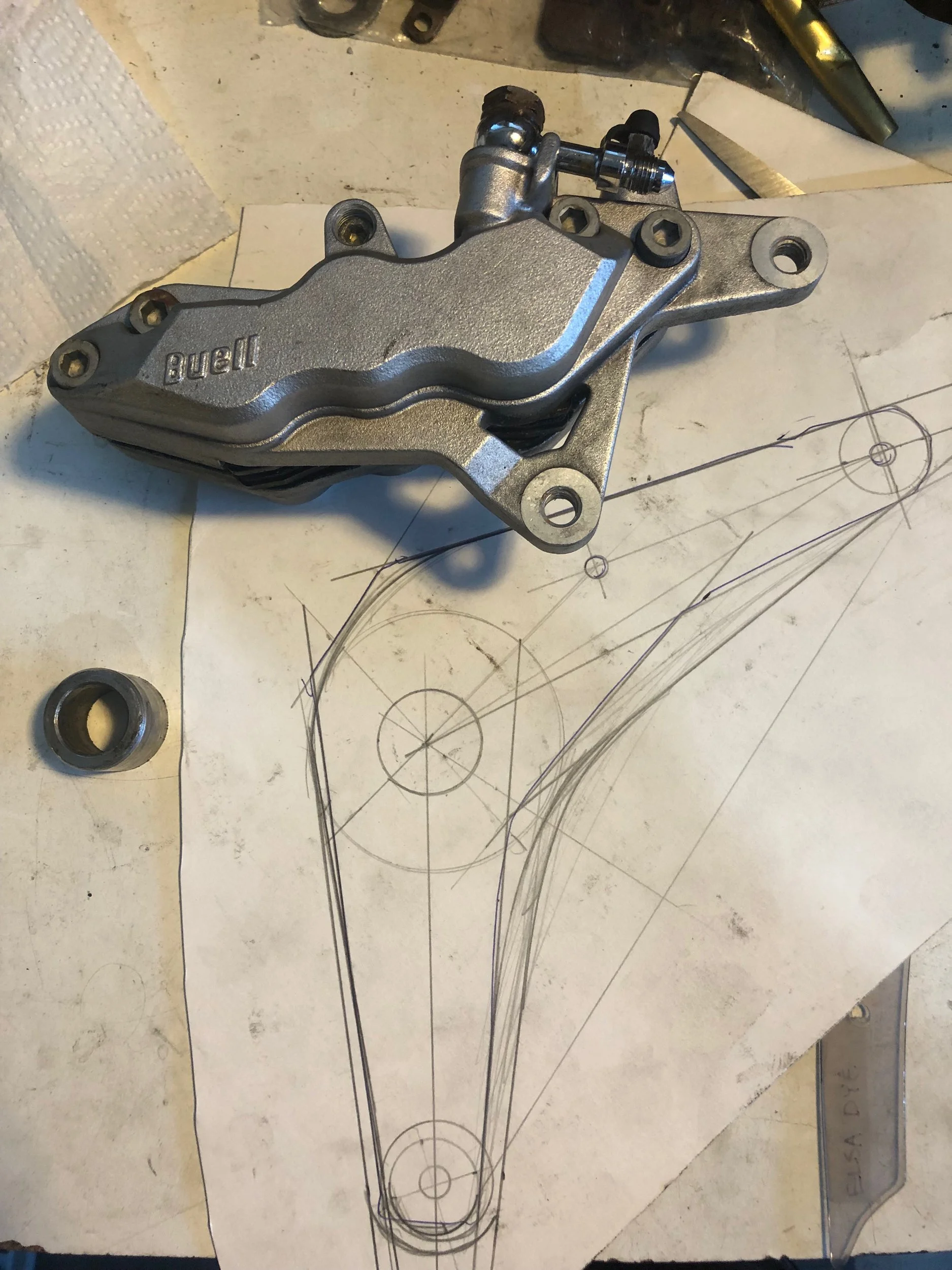  Design for a brake bracket to adapt a three piston Buell brake caliper to a ¾ axle Harley wheel for more stopping power. 