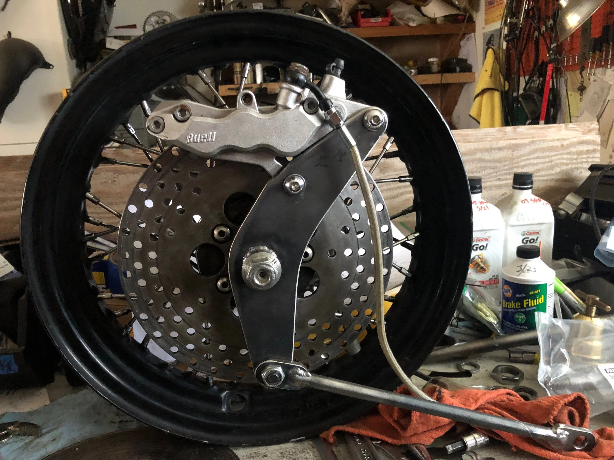  Buell three piston brake caliper mount for ¾ Harley wheel (with stay).  Works a million times better than the chunky/ineffective stock setup.  