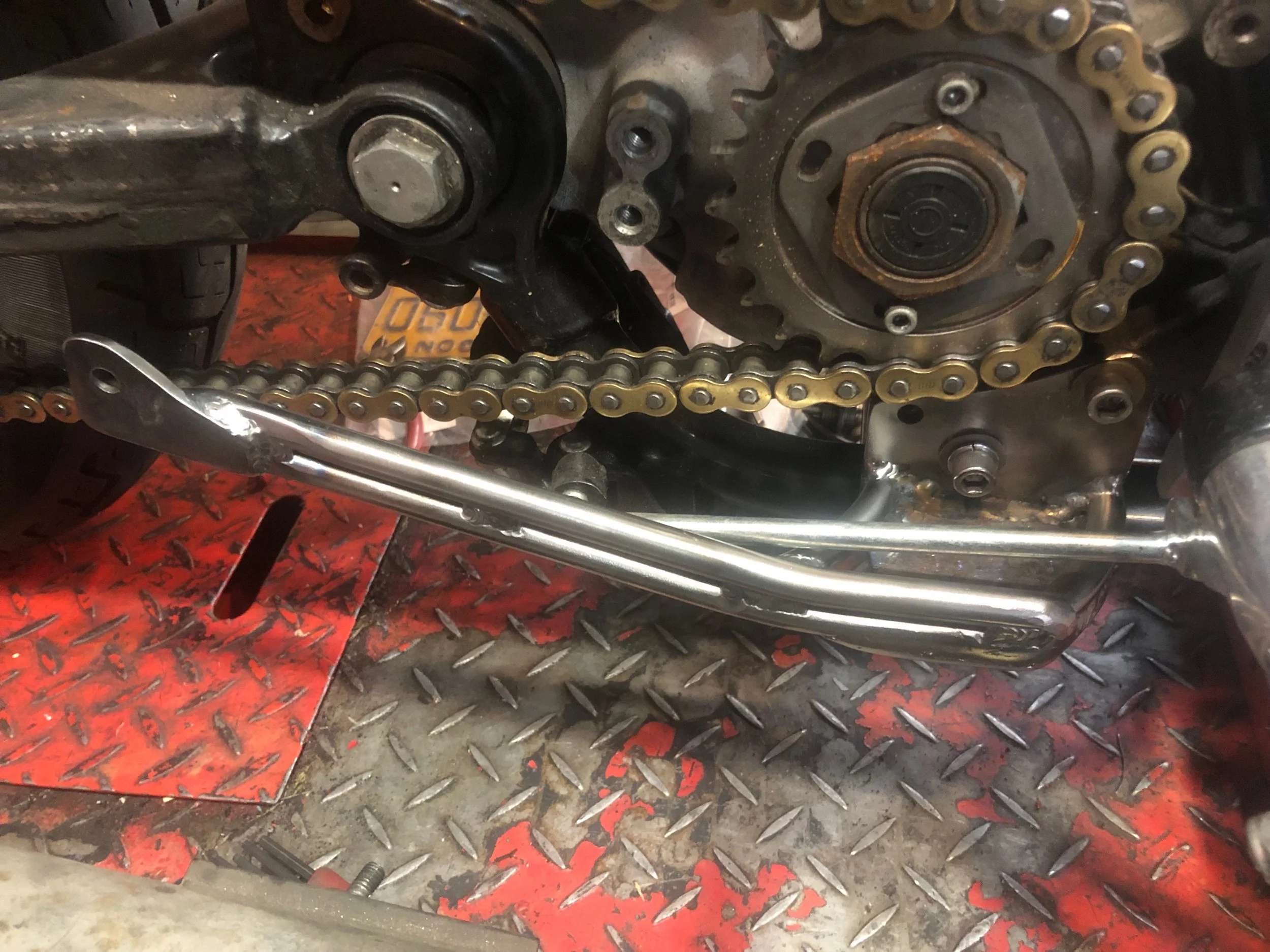 Exhaust bracket for a custom rubber-mount Sportster exhaust. 