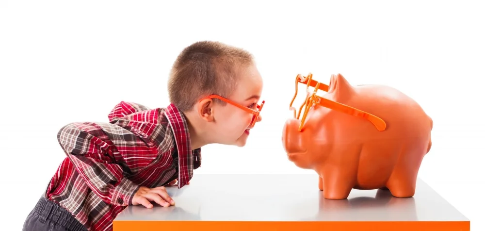 Kid and piggy bank.jpeg