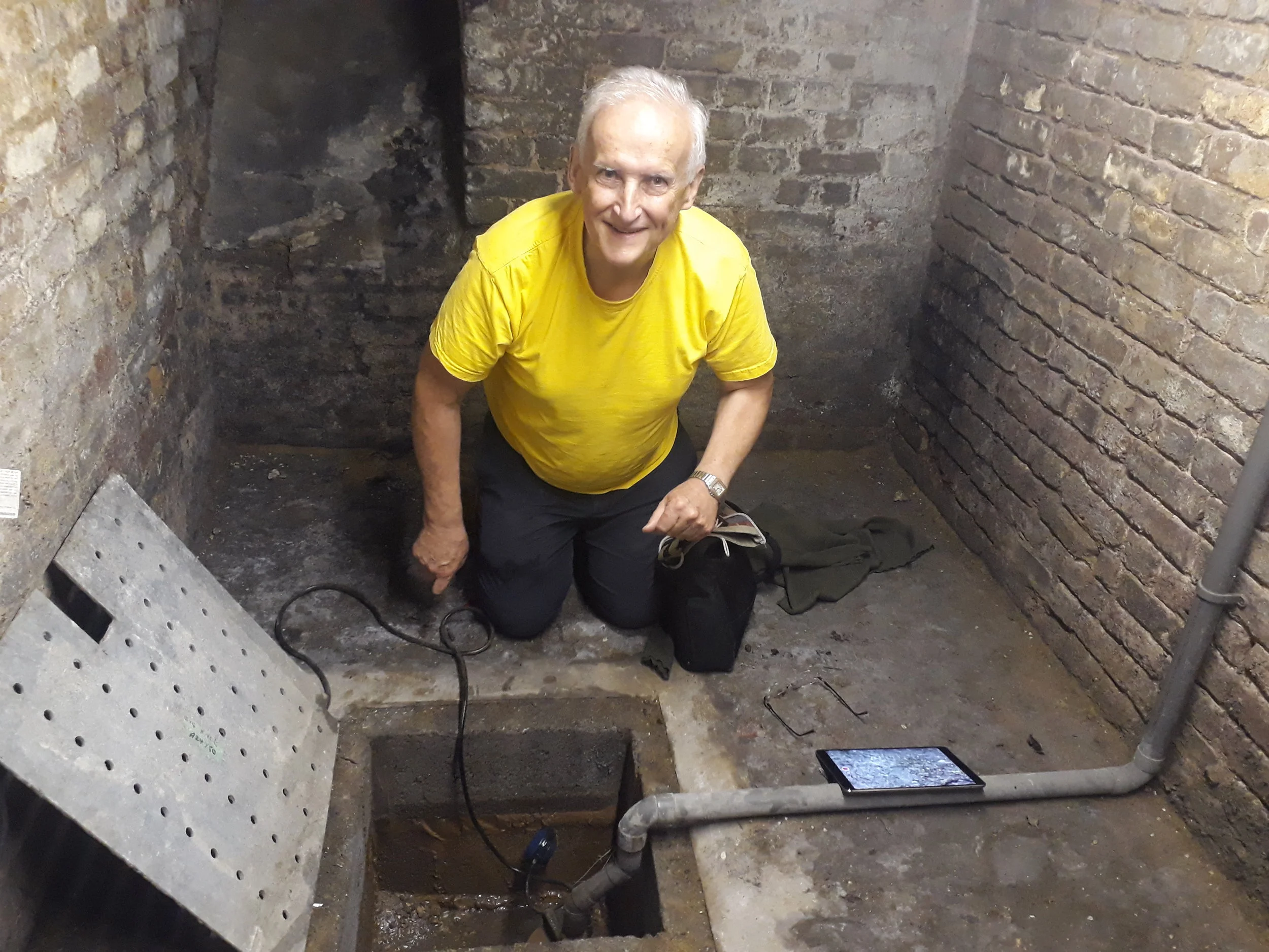 Fr James at the spring in the cellar