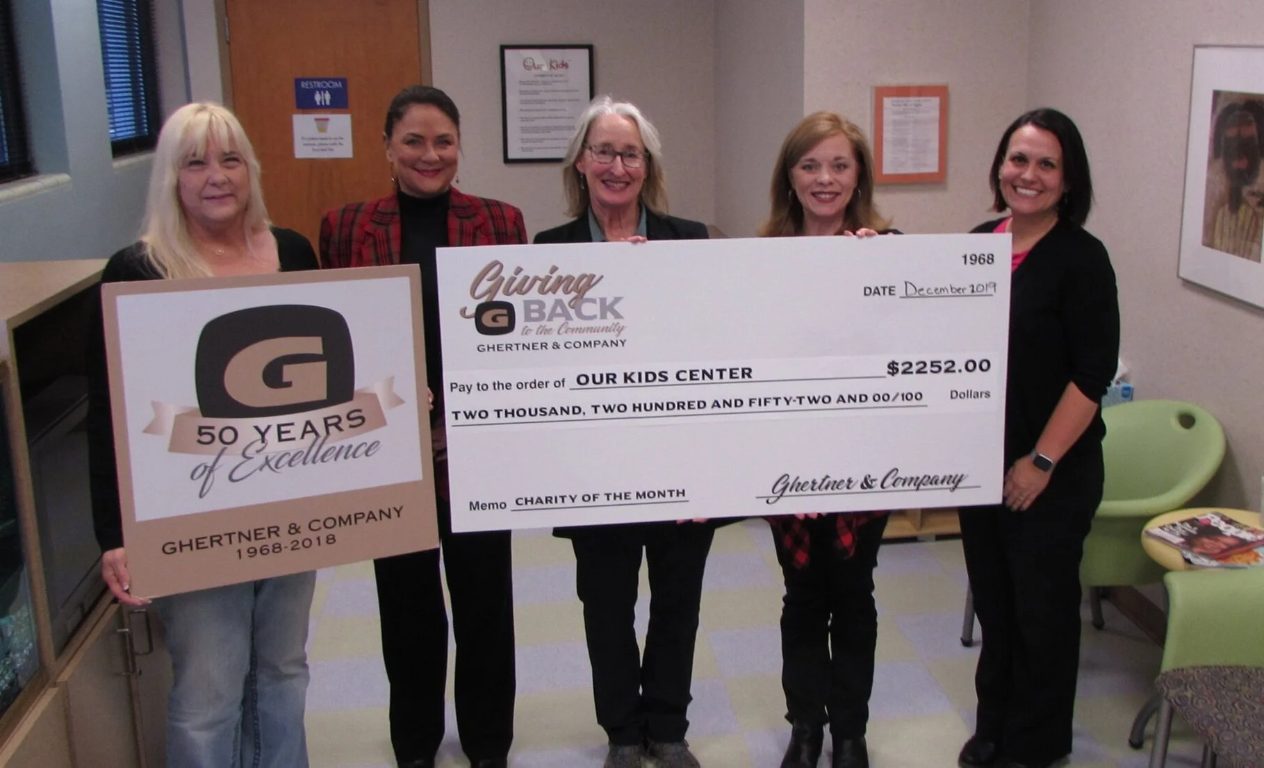    On December 6, representatives from Ghertner & Company presented the donation to the Our Kids Center team. Present are Jaye Kloss, Janice Tantaris, Sue Fort White (Our Kids Executive Director), Jill Martindale (Our Kids Communication Coordinator) and Kimberly Maynord.   